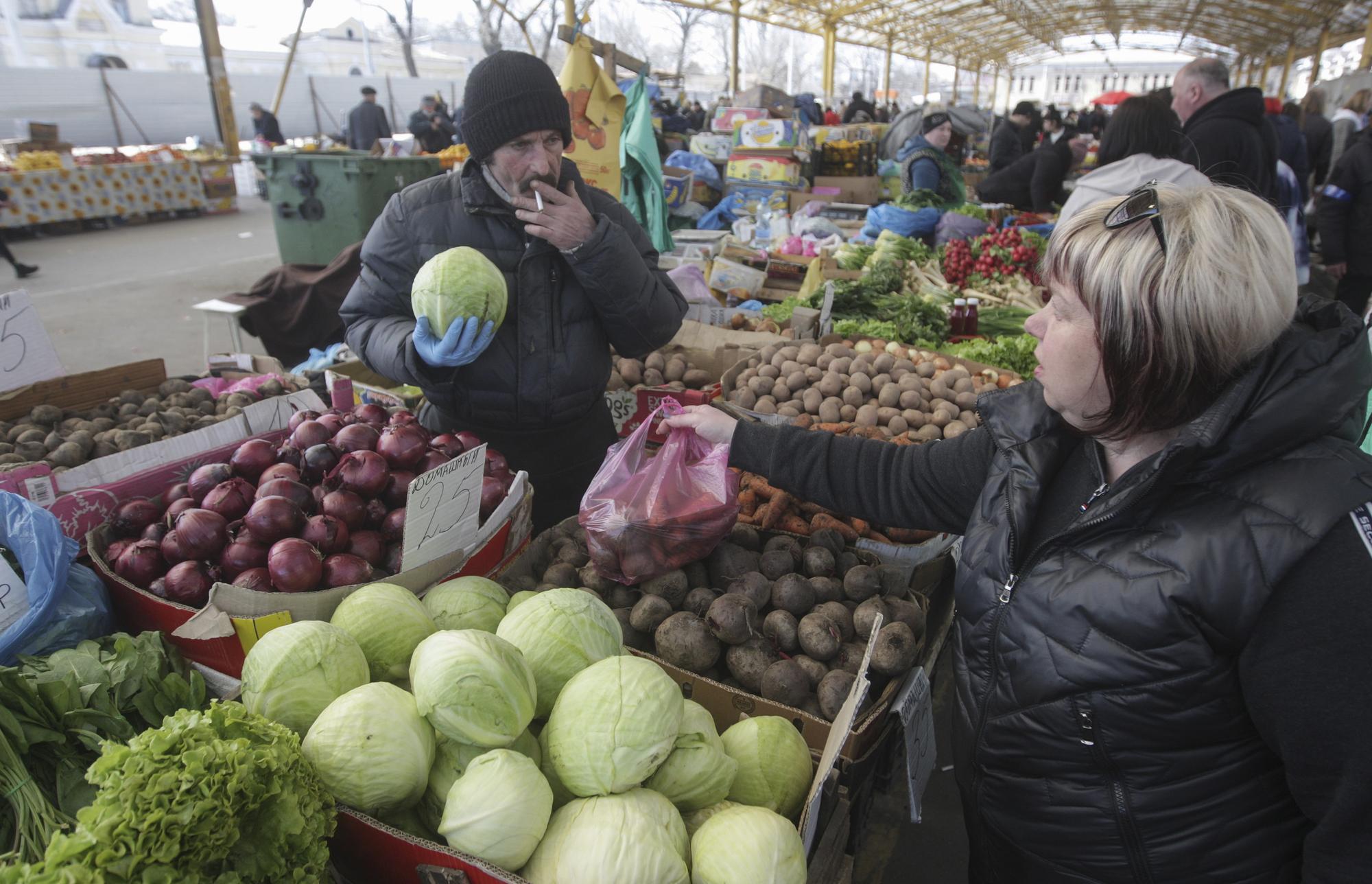epa09846837 Local people shop at Privoz Market in the south Ukrainian city of Odesa, Ukraine, 24 March 2022, amid the Russian invasion of Ukraine. The famous historical Privoz Market, located in downtown Odesa, is the largest food market in the city and was founded in 1827. On 24 February, Russian troops had entered Ukrainian territory in what the Russian president declared a 'special military operation', resulting in fighting and destruction in the country, a huge flow of refugees, and multiple sanctions against Russia. EPA/STEPAN FRANKO