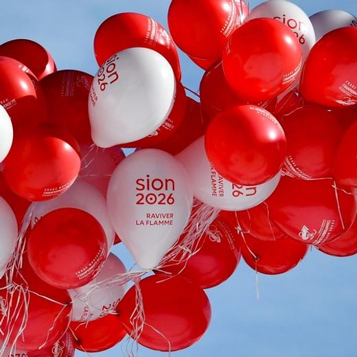 Balloons with a marked with the message "Sion 2026" promoting Switzerland's 2026 Winter Olympic Games bid rise into the sky during the Ski World Cup races event on March 4, 2018 in Crans-Montana, Swiss Alps.  The official race to succeed 2018 hosts Pyeongchang, and Beijing in 2022 begins in March when would be candidates file "letters of intention" to the International Olympic Committee. / AFP PHOTO / Fabrice COFFRINI