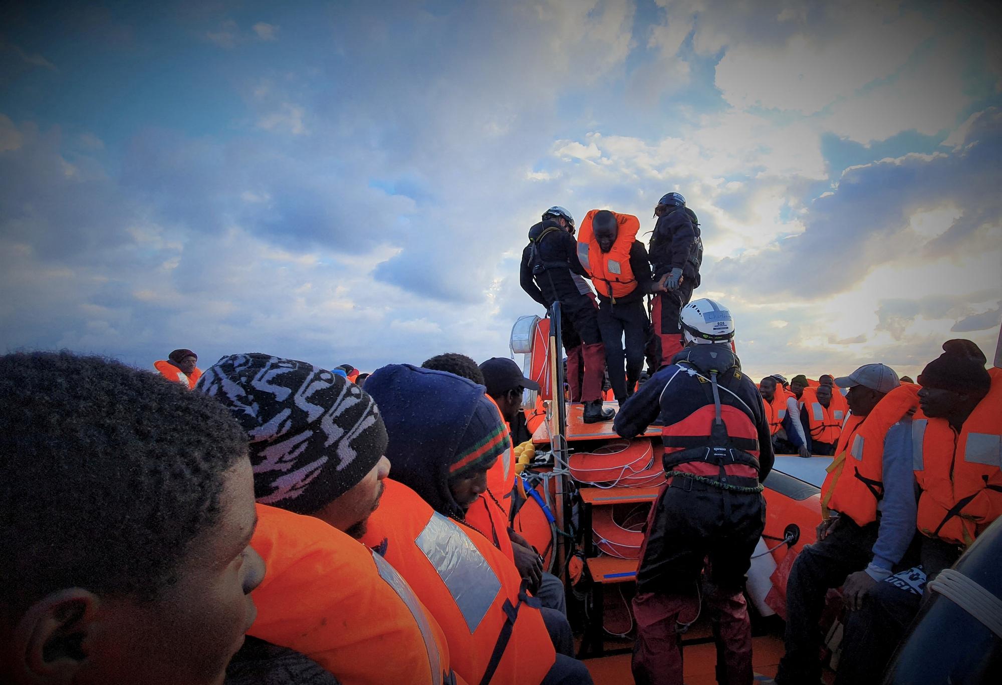 FILE PHOTO: Migrants wearing lifejackets are seen during a rescue operation by the MSF-SOS Mediterranee-run Ocean Viking rescue ship, off the coast of Libya in the Mediterranean Sea, February 18, 2020. Picture taken February 18, 2020. Hannah Wallace Bowman/MSF/Handout via REUTERS ATTENTION EDITORS - THIS PICTURE WAS PROVIDED BY A THIRD PARTY/File Photo