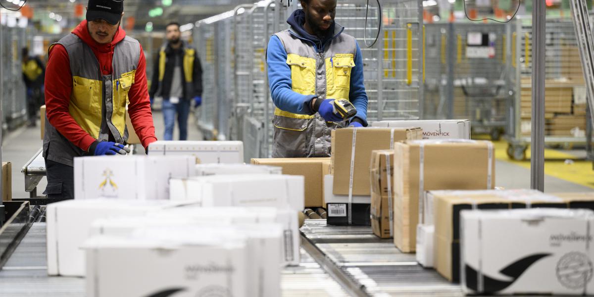 Des employes de la poste suisse trient des paquets fragile au centre colis de La Poste ce jeudi 15 decembre 2022 a Daillens, Vaud. Pendant les jours de pointe avant Noel, le volume depasse souvent les 230 000 colis. La capacite de tri maximale s'eleve a 19 000 colis par heure. En 2021, la Poste a trie au total 45,2 millions de colis a Daillens. (KEYSTONE/Laurent Gillieron)