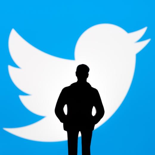 Twitter and Elon Musk deal concept. Figurine silhouette is seen in front of blurred Twitter logo on display. Stafford, United Kingdom, October 26, 2022.