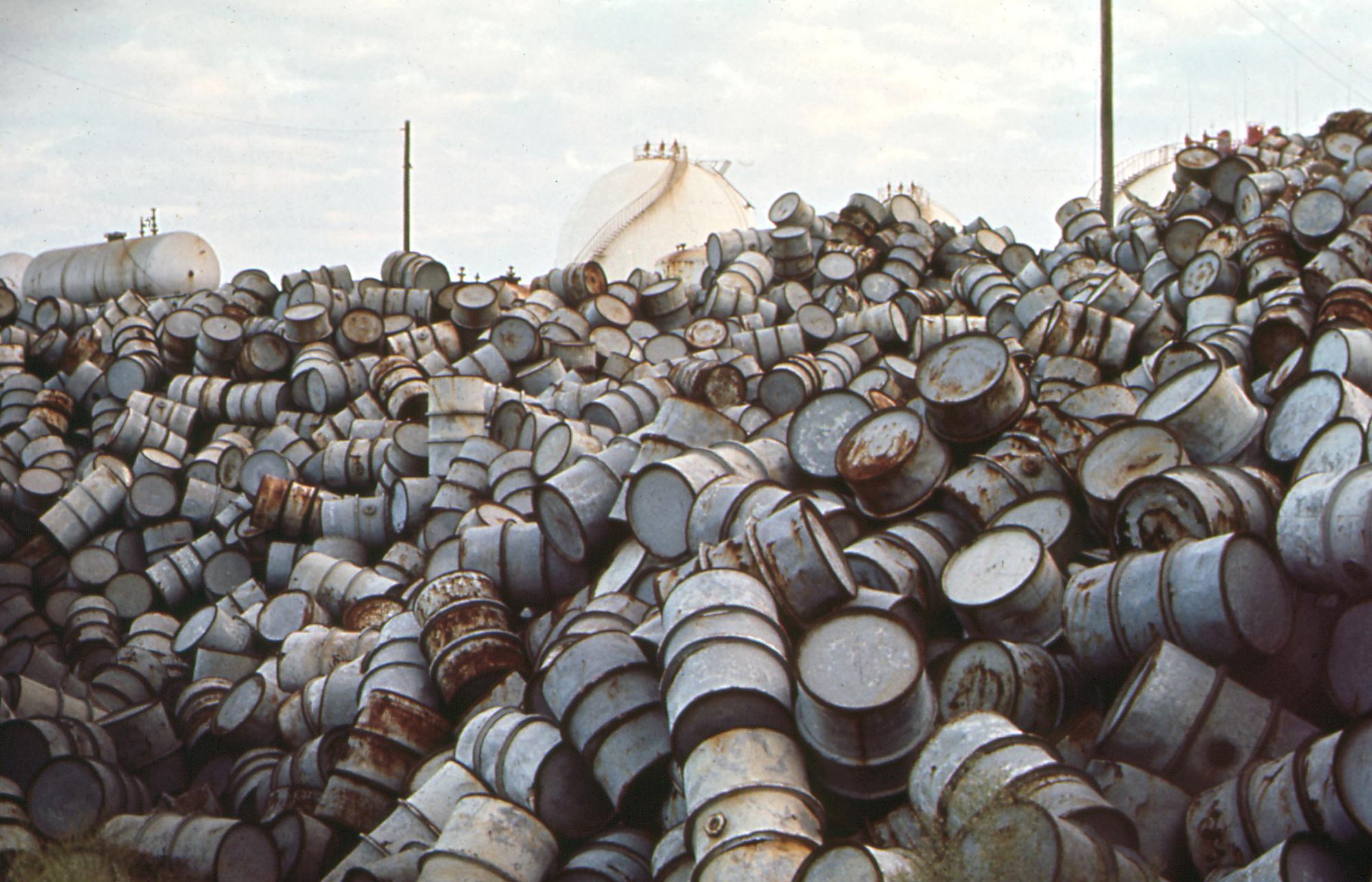 A mountain of damaged oil drums near the Exxon refinery; possibly Baton Rouge ca. December 1972. (Photo by: HUM Images/Universal Images Group via Getty Images)