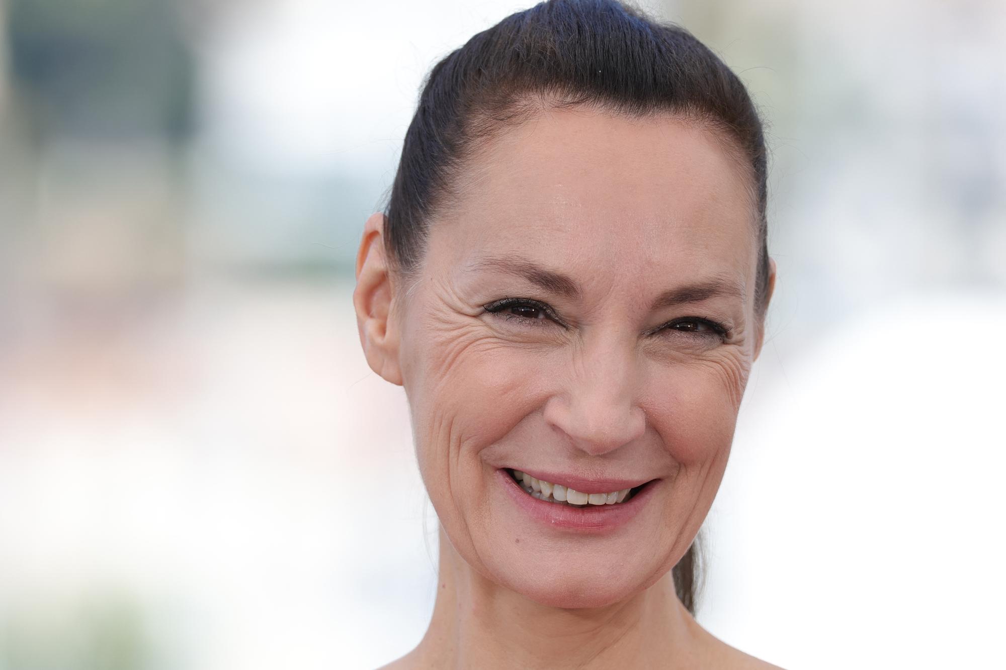 French actress Jeanne Balibar smiles during a photocall for the film "Irma Vep" at the 75th edition of the Cannes Film Festival in Cannes, southern France, on May 21, 2022. (Photo by Valery HACHE / AFP)