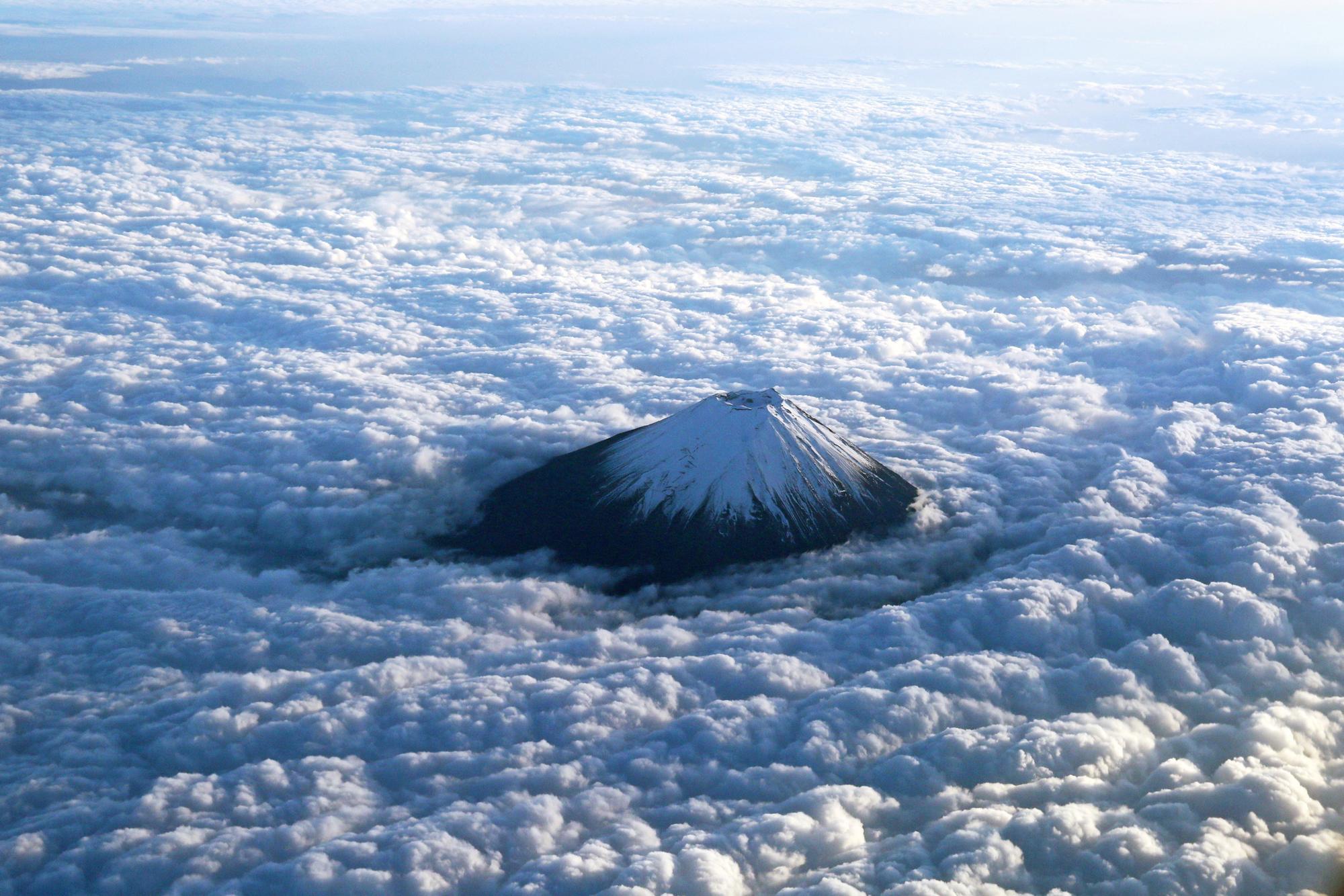 An aerial photo shows Mt. Fuji surrounded by clouds in Japan on November 7, 2018. 3776-meter-high Fujisan is the highest mountain in Japan.( The Yomiuri Shimbun ) (Photo by Masanobu Nakatsukasa / Yomiuri / The Yomiuri Shimbun via AFP)