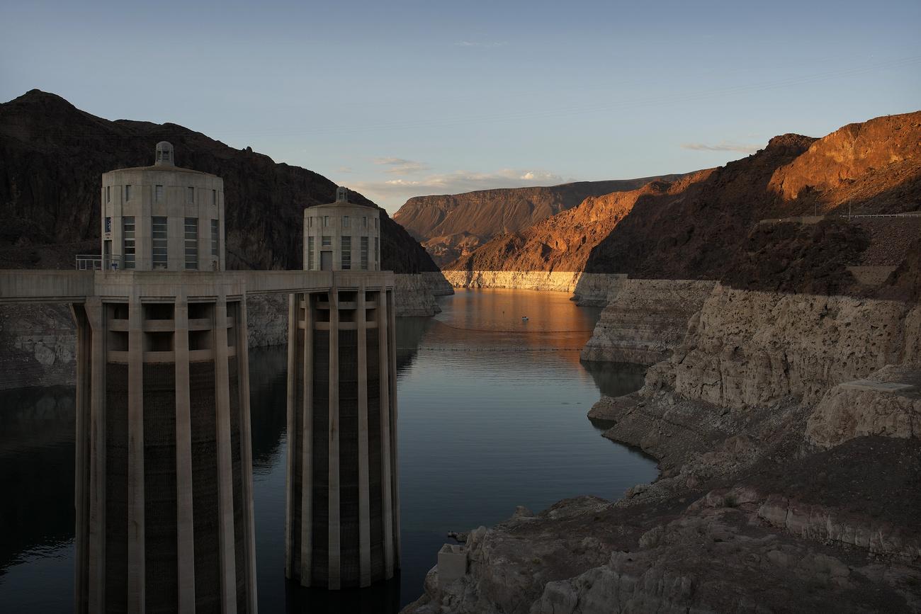 FILE - A bathtub ring of light minerals shows the high water line of Lake Mead near water intakes on the Arizona side of Hoover Dam at the Lake Mead National Recreation Area Sunday, June 26, 2022, near Boulder City, Nev. The words "dead pool" surfaced this week as officials described the possibility that lake levels could shrink so much that neither dam would be able to release water downstream. The first weeks of 2023 will be crucial for Southwest U.S. states and water entities to agree how to use less water from the drought-stricken and fast-shrinking Colorado River, a top federal water manager said Friday, Dec. 16, 2022. (AP Photo/John Locher, File)