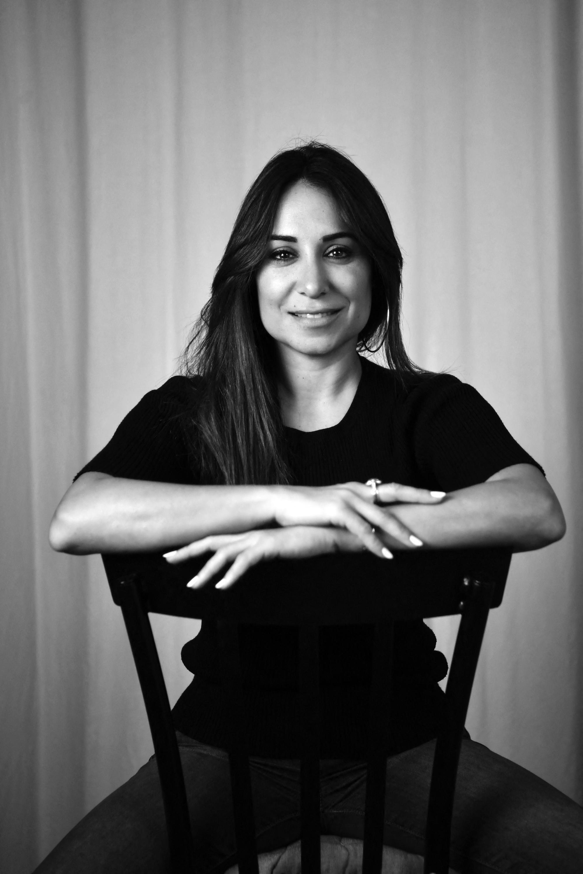 Erige Sehiri, French-Tunisian director and producer, poses for a studio photo shoot in Tunisia's capital Tunis on November 12, 2022. - The Tunisian director of "Under the Fig Trees", which portrays young harvest workers, said she hoped the award-winning film would "smash the cliche" that rural women are "miserable and closed". The film won the silver Tanit award at the 2022 Carthage Film Festival (JCC) in November. In an interview, Sehiri told AFP her first feature-length work relates the secrets, love stories and resentments of the mostly female "modern and connected" workers. (Photo by Fethi Belaid / AFP)