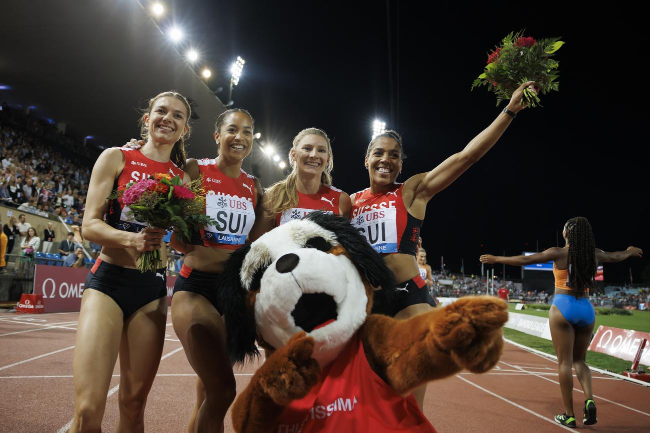 Geraldine Frey, Salome Kora, Ajla Del Ponte, and Mujinga Kambundji of Switzerland, from left, pose after winning the 4x100m Relay at the Athletissima IAAF Diamond League international athletics meeting in the Stade Olympique de la Pontaise in Lausanne, Switzerland, Friday, August 26, 2022. (KEYSTONE/Valentin Flauraud)