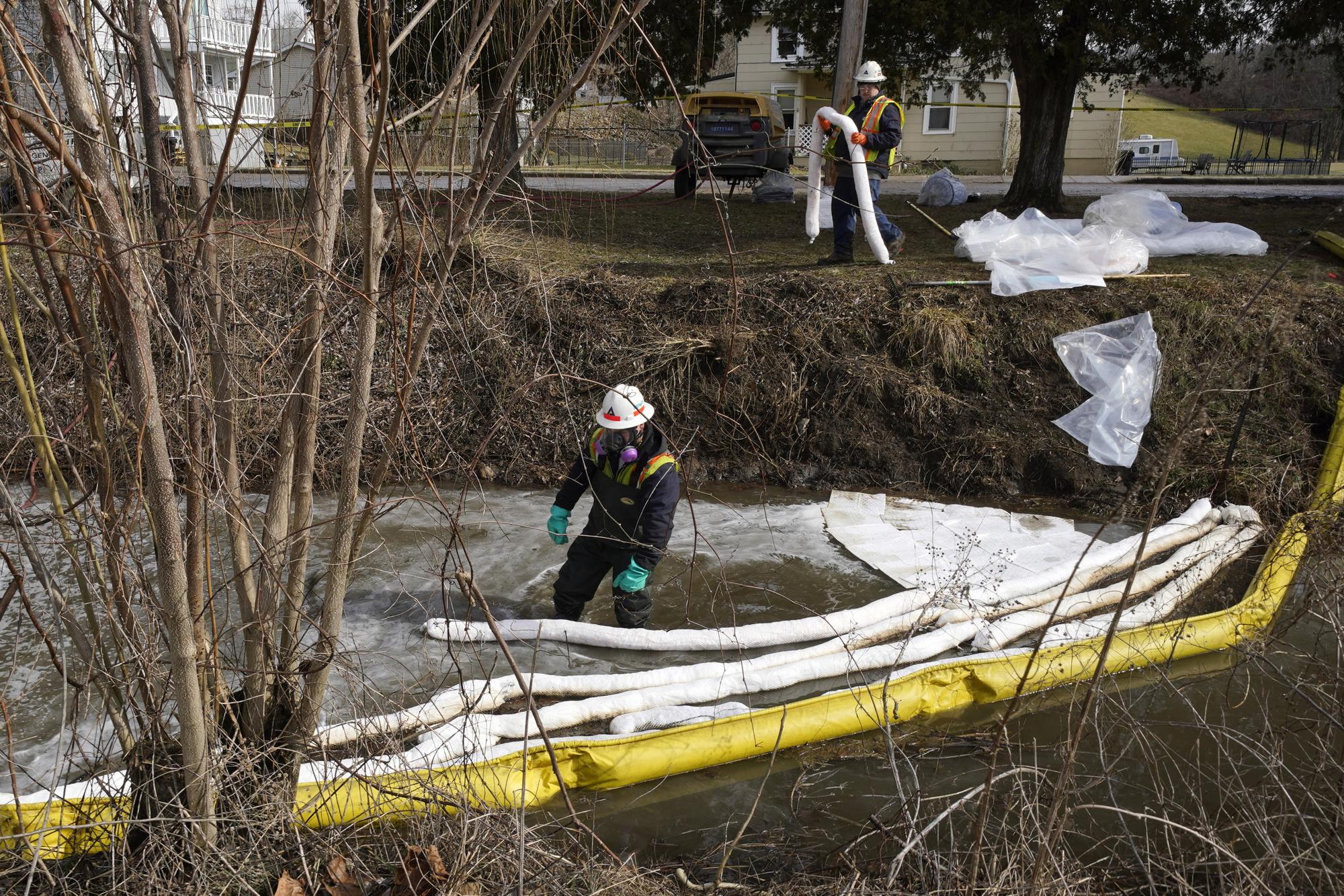 HEPACO workers place booms in a stream in East Palestine, Ohio, Thursday, Feb. 9, 2023 as the cleanup continues after the derailment of a Norfolk Southern freight train Friday. (AP Photo/Gene J. Puskar)
