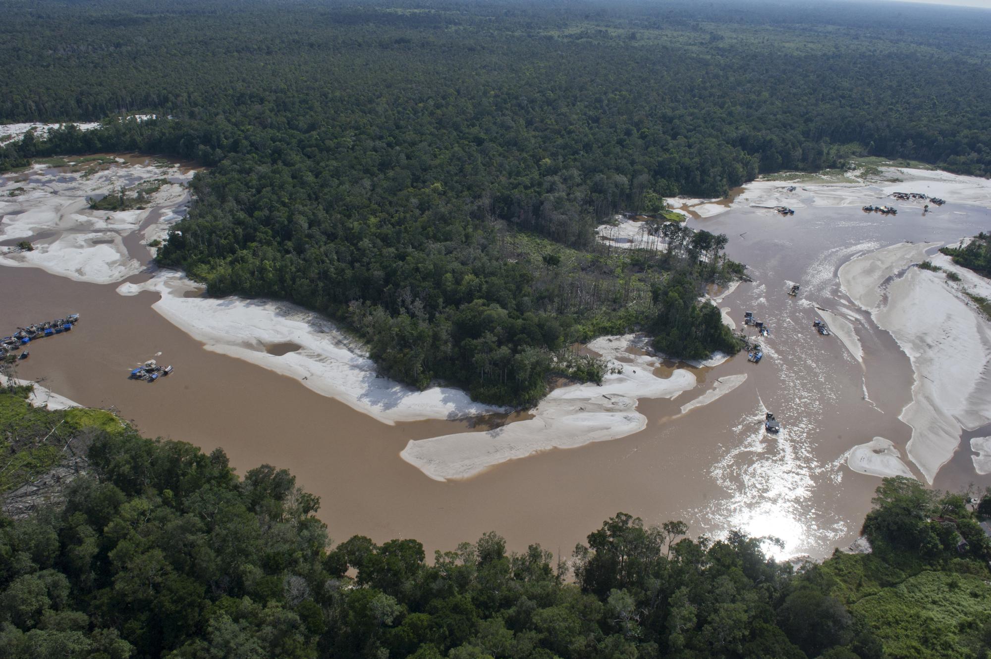 This aerial photograph taken on June 7, 2012 in Central Kalimantan province in Indonesia's Borneo island shows an illegal gold mining operation on a riverway where miners' use of mercury pollute the river and land causing environmental devastation, posing risk to health and poisoning communities. In a desolate area of central Indonesia that was once lush rainforest, illegal miners on the frontline of a modern-day gold rush tear up the earth in the hunt for the precious metal. But the mercury used to extract it is taking an even greater toll. Kalimantan has been named as one of the most polluted places in the world in 2013. AFP PHOTO / ROMEO GACAD (Photo by ROMEO GACAD / AFP)
