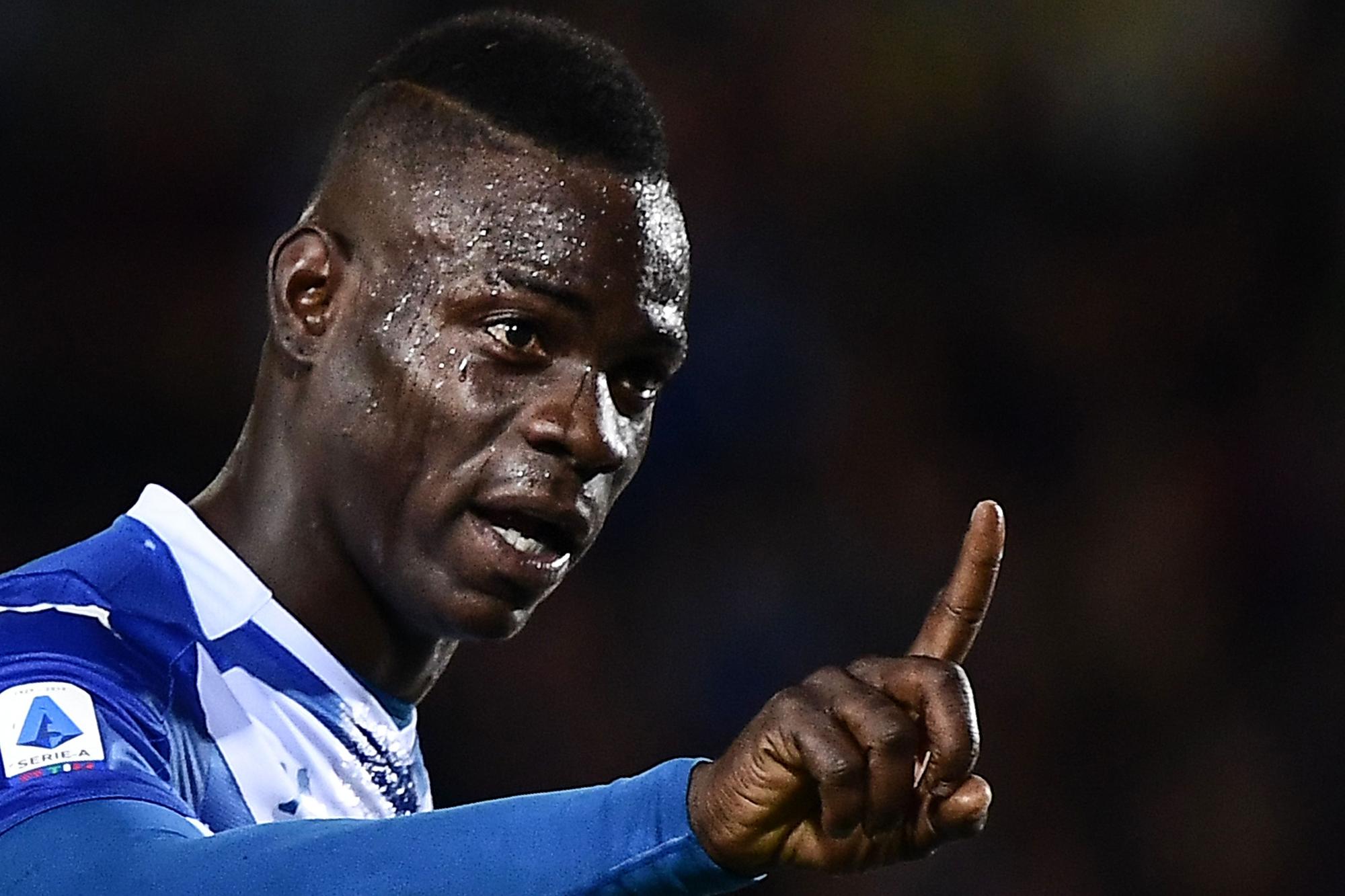 (FILES) In this file photo taken on September 24, 2019 Brescia's Italian forward Mario Balotelli gestures towards Juventus fans during the Italian Serie A football match Brescia vs Juventus at the Mario-Rigamonti stadium in Brescia. - Mario Balotelli on November 3, 2019 thanked his fellow players and supporters for their support after he was racially abused by Hellas Verona fans, the latest in a series of ugly incidents that have blighted the early weeks of the Serie A season. (Photo by Marco Bertorello / AFP)