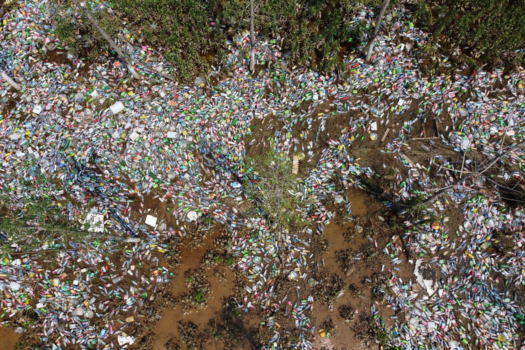 Plastic bottles are seen in a ditch where floodwaters have receded following heavy rainfall in Xinxiang, Henan province, China July 25, 2021. Picture taken with a drone. REUTERS/Aly Song