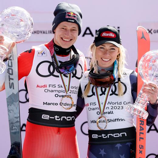 Alpine Skiing - FIS Alpine Ski World Cup - Men's Slalom - Soldeu, Andorra - March 19, 2023  Switzerland's Marco Odermatt and Mikaela Shiffrin of the U.S. celebrate on the podium with their globe trophies after winning the men's and women's overall standing REUTERS/Albert Gea