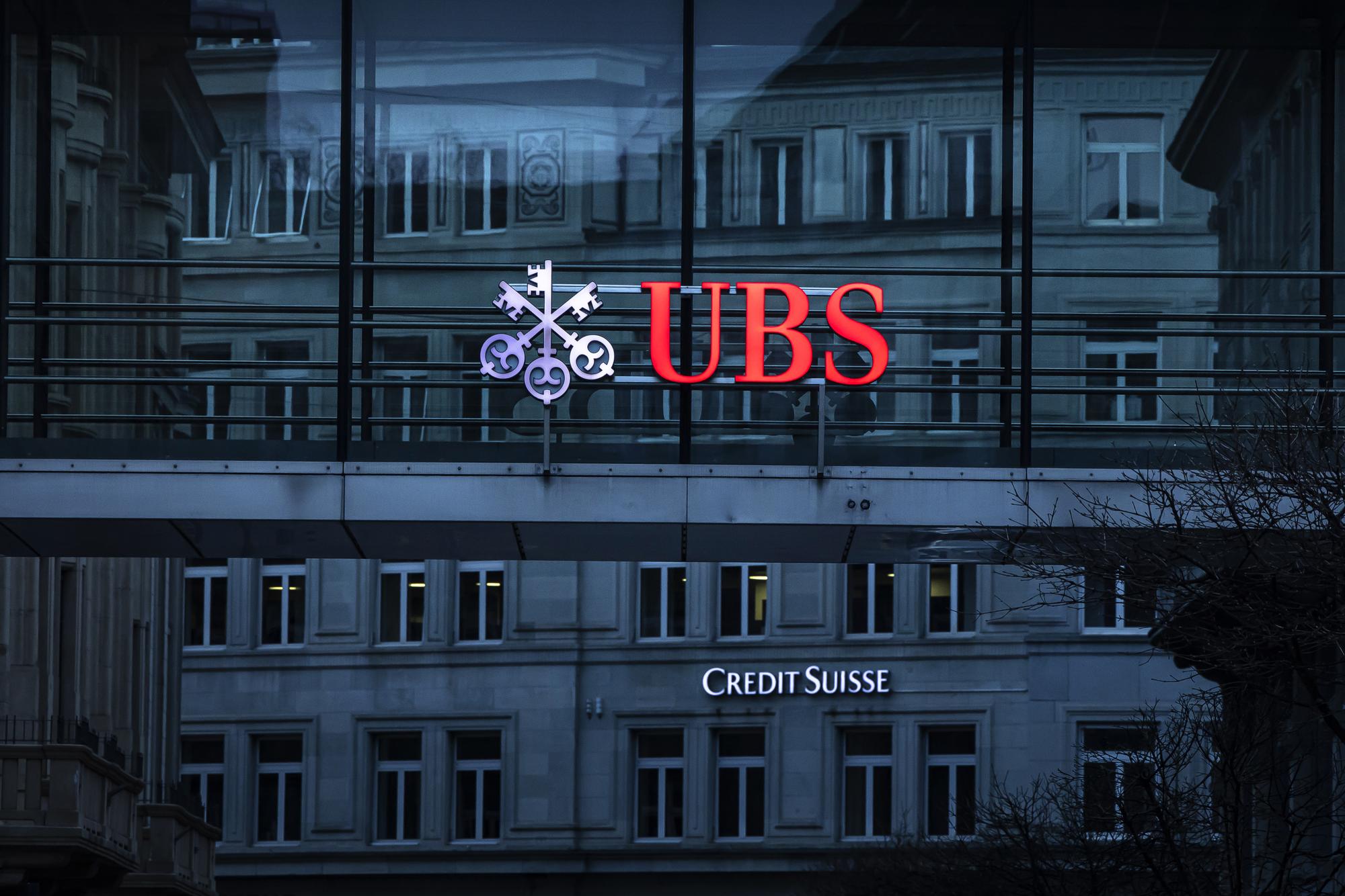 The logos of the Swiss banks Credit Suisse and UBS are displayed on different buildings in Zurich, Switzerland on Sunday March 19, 2023. (KEYSTONE/Michael Buholzer).