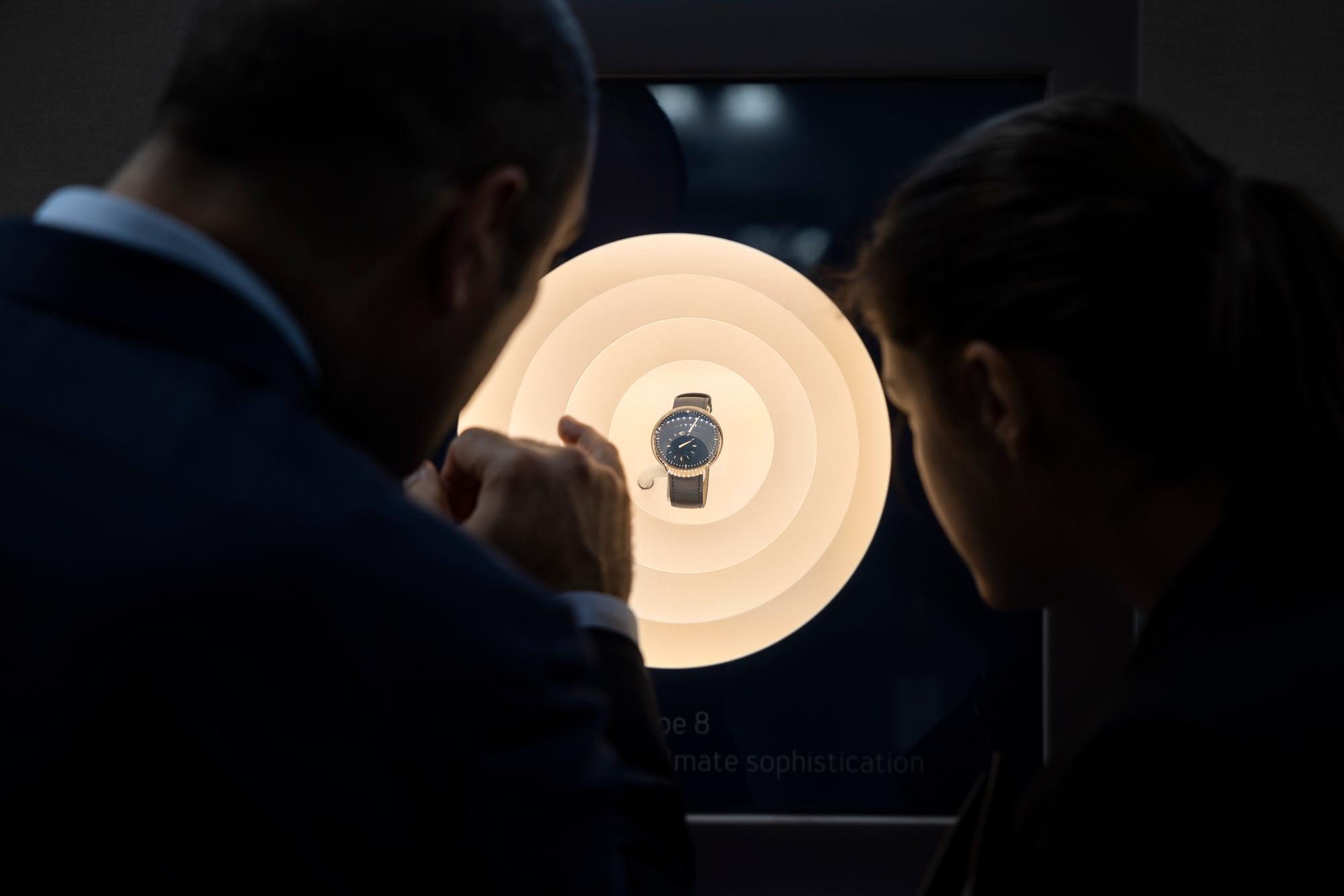 Visitors look a watch in a window during the Watches and Wonders GENEVA, in Geneva, Switzerland, Thursday, March 31, 2022. The Master Event of the Watches and Wonders ecosystem brings together the leading names of the Watchmaking and luxury industry from March 30 to April 5, 2022 at Geneva Palexpo. (KEYSTONE/Cyril Zingaro)
