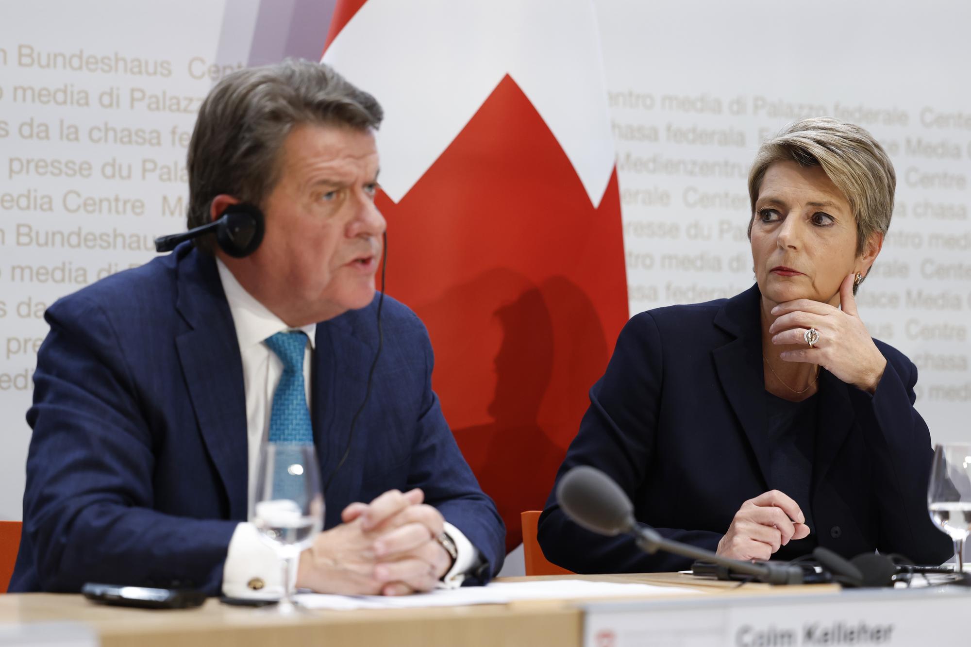 Colm Kelleher, Chairman UBS, left, speaks beside Swiss Finance Minister Karin Keller-Sutter, during a press conference, on Sunday, 19 March 2023 in Bern. Switzerland's largest bank UBS agreed to take over Credit Suisse for $3 billion Swiss francs ($3.25 billion) in a government-brokered deal over the weekend following days of market upheaval over the health of the banking sector. (KEYSTONE/Peter Klaunzer)