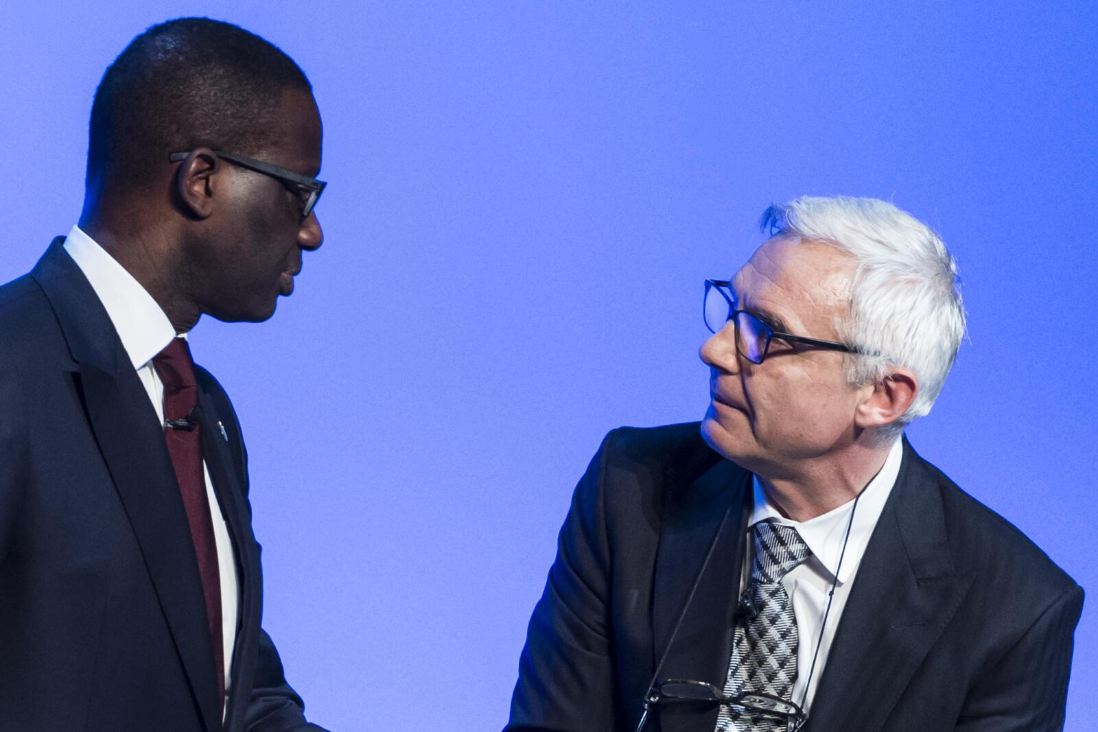 FILE --- Tidjane Thiam, left, CEO Credit Suisse, and Urs Rohner, right, chairman Credit Suisse, after an extraordinary general assembly in Bern, Switzerland, Thursday, November 19, 2015. Credit Suisse said Friday, February 7, 2020, Chief Executive Officer Thiam is resigning. Thiam will be replaced by Thomas Gottstein, a 20-year veteran of the bank who leads the Swiss unit. (KEYSTONE/Dominic Steinmann)