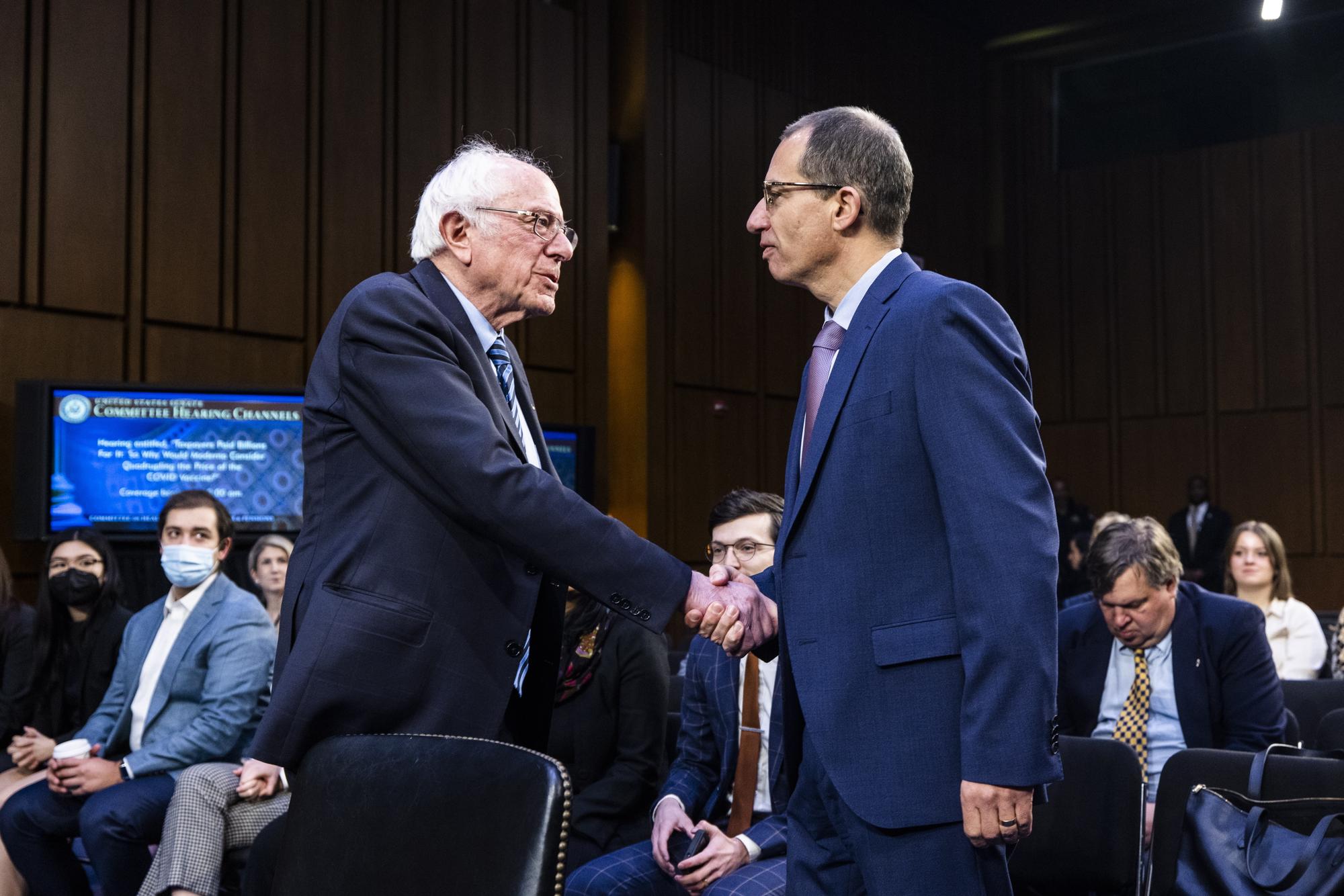 epa10536933 Moderna CEO Stephane Bancel (R) greets Independent Senator from Vermont Bernie Sanders (L) prior to testifying before the Senate Health, Education, Labor and Pensions Committee about the company's pricing strategy in the Hart Senate Office Building in Washington, DC, USA, 22 March 2023. Moderna said they are considering pricing their COVID-19 vaccine at about 130 US dollar per dose in the US. EPA/JIM LO SCALZO
