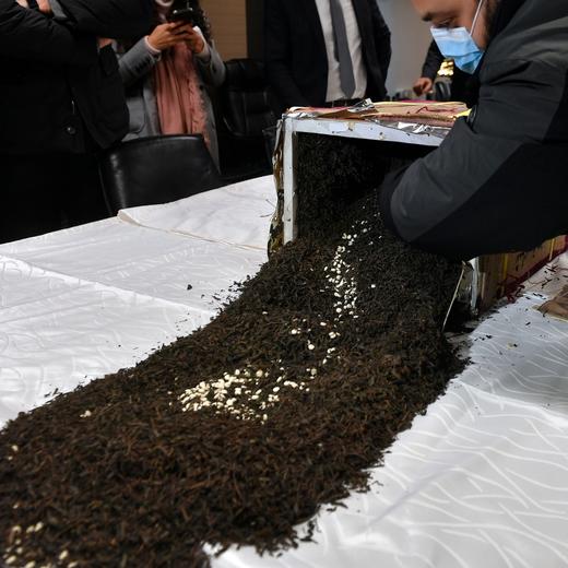epa09708963 A member from Internal Security Forces displays confiscated amphetamine Captagon pills which were hidden in 434 tea boxes mixed with seven tons of tea for export, at the headquarters of the Internal Security Forces (ISF) in Beirut, Lebanon, 25 January 2022. Lebanese Interior Minister Bassam Mawlawi said Lebanese police thwarted the attempt to smuggle large amounts of Captagon, which were hidden in 434 tea boxes that were on their way from Lebanon to the African nation of Togo to be sent from there to a Persian Gulf nation. EPA/WAEL HAMZEH
