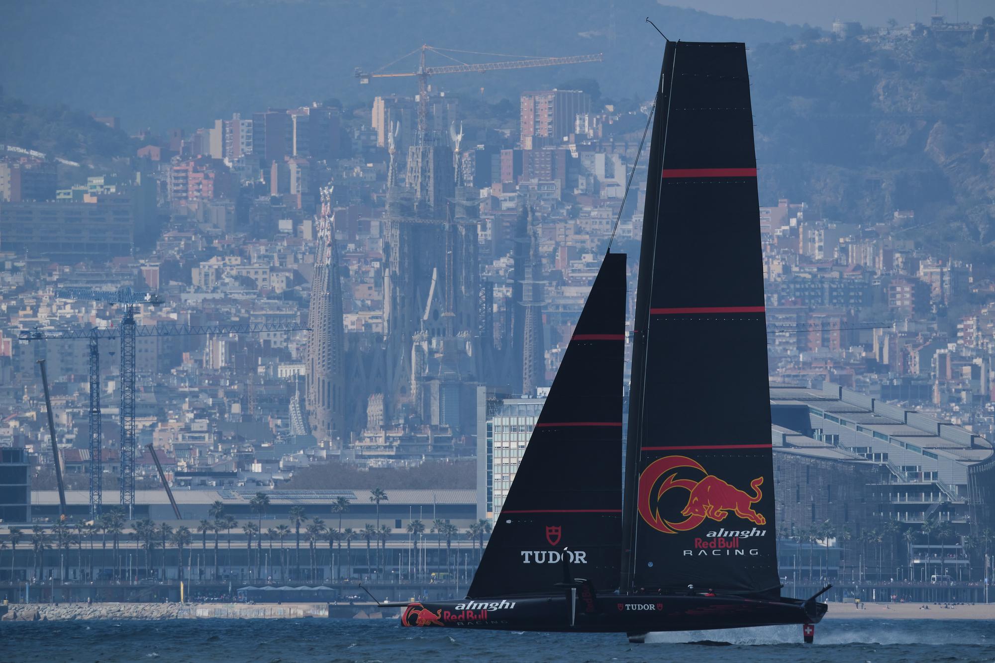 Alinghi Red Bull Racing's AC75 boat Zero sails passed the Sagrada Familia temple during a training session as part of Alinghi Red Bull Racing Press Day in Barcelona, Spain on March 23, 2023.