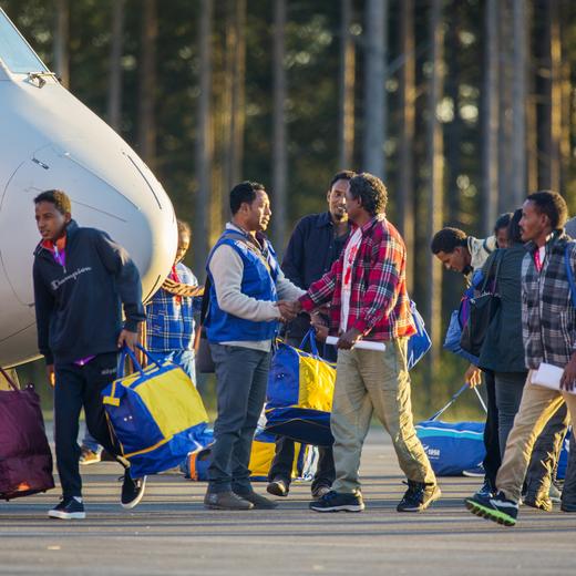 Eritrean asylum seekers arrive by an Italian Financial police aircraft to Lulea Airport, Kallax northern Sweden, Friday, Oct. 9, 2015. Italy bid farewell Friday to 19 Eritreans — the first of an estimated 160,000 refugees to be resettled throughout Europe as part of a new EU redistribution program to move asylum-seekers out of hard-hit front-line countries. Bundled up in flannel shirts and jackets to prepare for their new lives in Sweden they landed in Lulea, just south of the Arctic Circle. Swedish officials now must register the refugees and begin processing their asylum requests. Sweden's immigration agency said the 14 men and five women, who ranged from 25 to 40 years old, were selected because they have a chance of being granted asylum and have family or other connections to Sweden. (Robert Nyholm/TT via AP) SWEDEN OUT