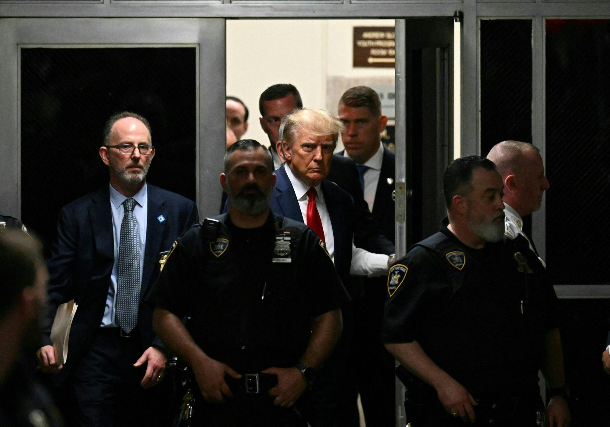 Former US President Donald Trump makes his way inside the Manhattan Criminal Courthouse in New York on April 4, 2023. - Donald Trump will make an unprecedented appearance before a New York judge on April 4, 2023 to answer criminal charges that threaten to throw the 2024 White House race into turmoil. (Photo by Ed JONES / AFP)