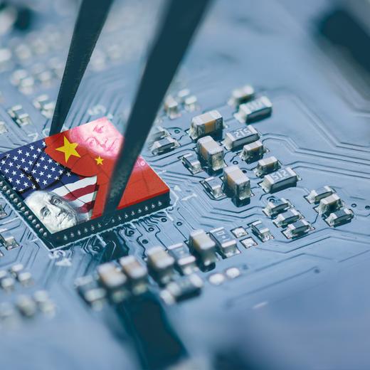 Flag of USA and China on a processor, CPU or GPU microchip on a motherboard. US companies have become the latest collateral damage in US - China tech war. US limits, restricts AI chips sales to China.