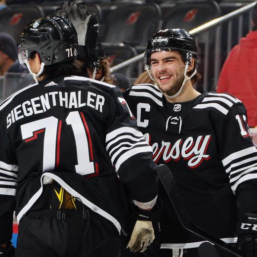 NEWARK, NEW JERSEY - APRIL 11: Nico Hischier #13 (R) celebrates a second period goal by Jonas Siegenthaler #71 of the New Jersey Devils (L) against the Buffalo Sabres at the Prudential Center on April 11, 2023 in Newark, New Jersey. Bruce Bennett/Getty Images/AFP (Photo by BRUCE BENNETT / GETTY IMAGES NORTH AMERICA / Getty Images via AFP)