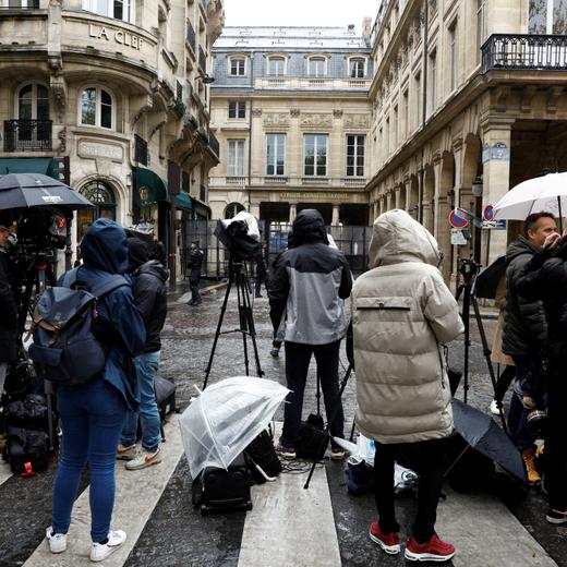 Journalists work in a street as French gendarmes block the access to the Constitutional Council (Conseil Constitutionnel) the day of its decision on the admissibility of the government's pension reform law, which was adopted in parliament without a vote, using the 49.3 clause of the constitution, in Paris, France, April 14, 2023. REUTERS/Gonzalo Fuentes
