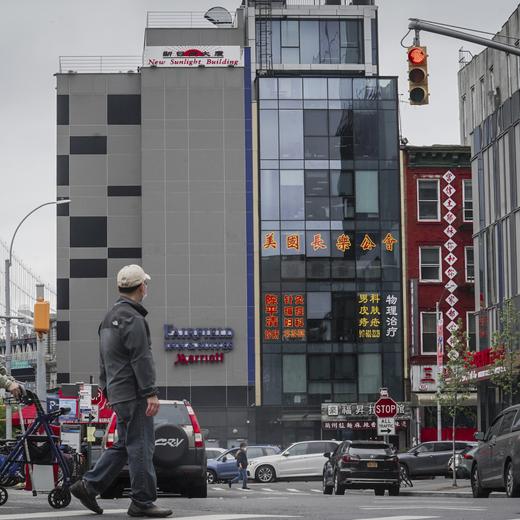 A six story glass facade building, center, is believed to be the site of a foreign police outpost for China in New York's Chinatown, Monday, April 17, 2023. Justice Department officials say two men have been arrested on charges that they helped establish a secret police outpost in New York City on behalf of the Chinese government. (AP Photo/Bebeto Matthews)
