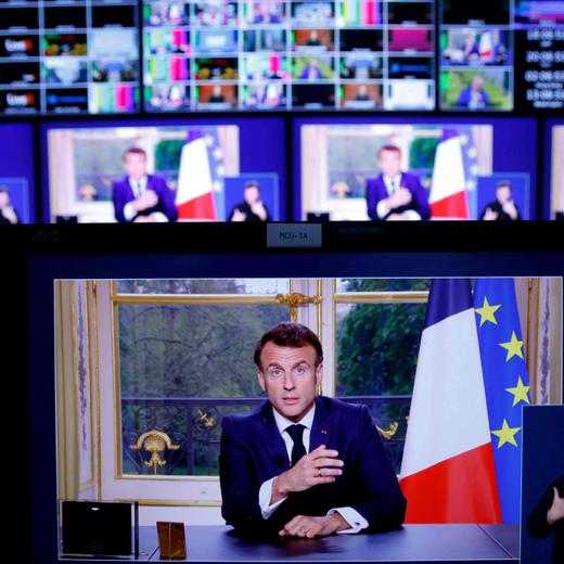 A photo of monitors in a media control room shows French President Emmanuel Macron during a televised address to the nation, made from the Elysee Palace, after signing into law a pensions reform, in Paris, on April 17, 2023. - French President Emmanuel Macron on April 15 addressed France for the first time since signing into law his controversial pension reform, facing warnings the political and social crisis it sparked is not over. Macron signed the legislation just hours after the banner change to raise the retirement age from 62 to 64 had been validated by the constitutional court on April 14, prompting accusations he was smuggling the law through in the dead of night. (Photo by Ludovic MARIN / AFP)