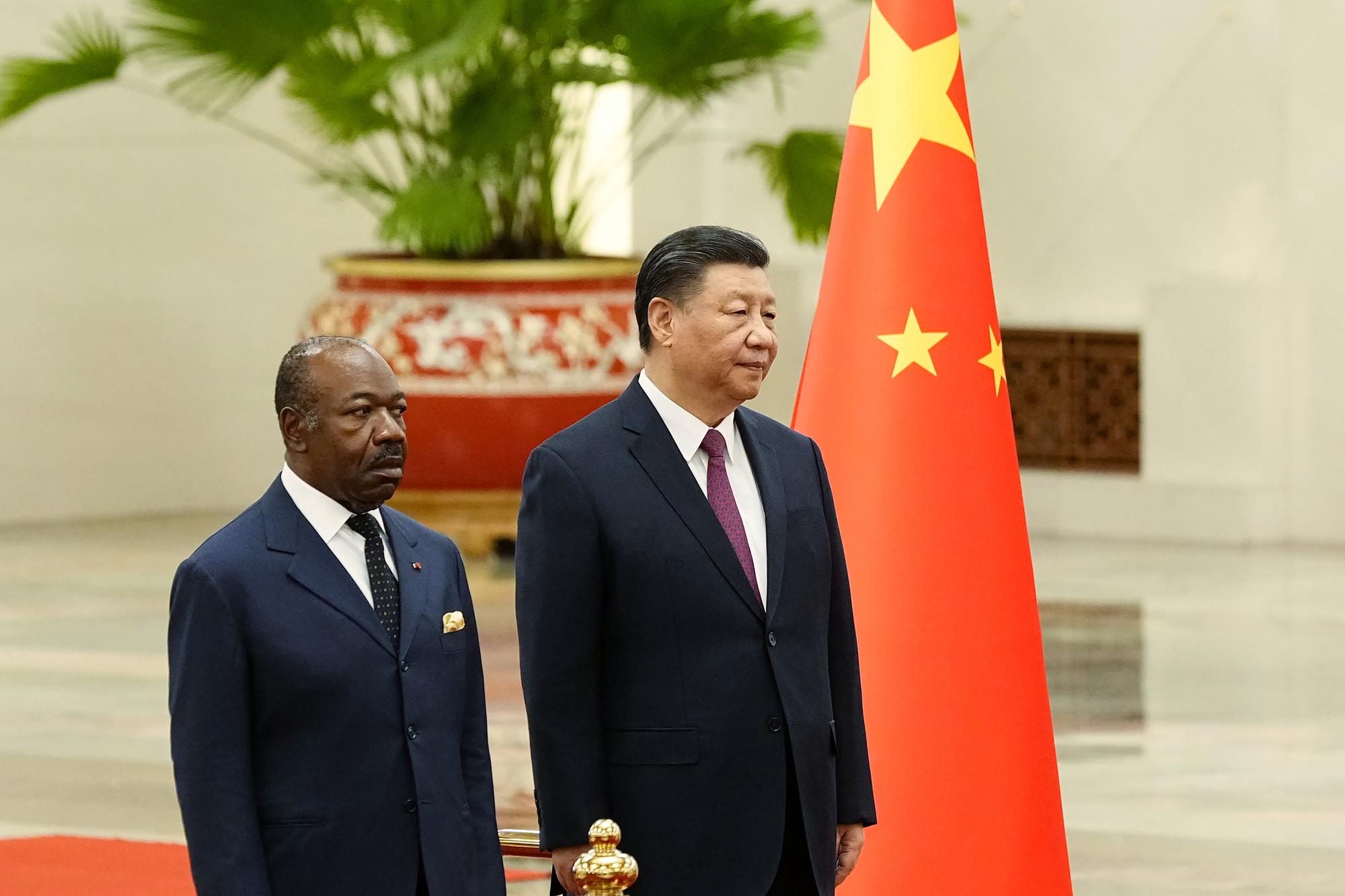 Gabonese President Ali Bongo Ondimba, left, and Chinese President Xi Jinping inspect an honor guard during a welcome ceremony at the Great Hall of the People in Beijing, Wednesday, April 19, 2023. (Ken Ishii/Pool Photo via AP)