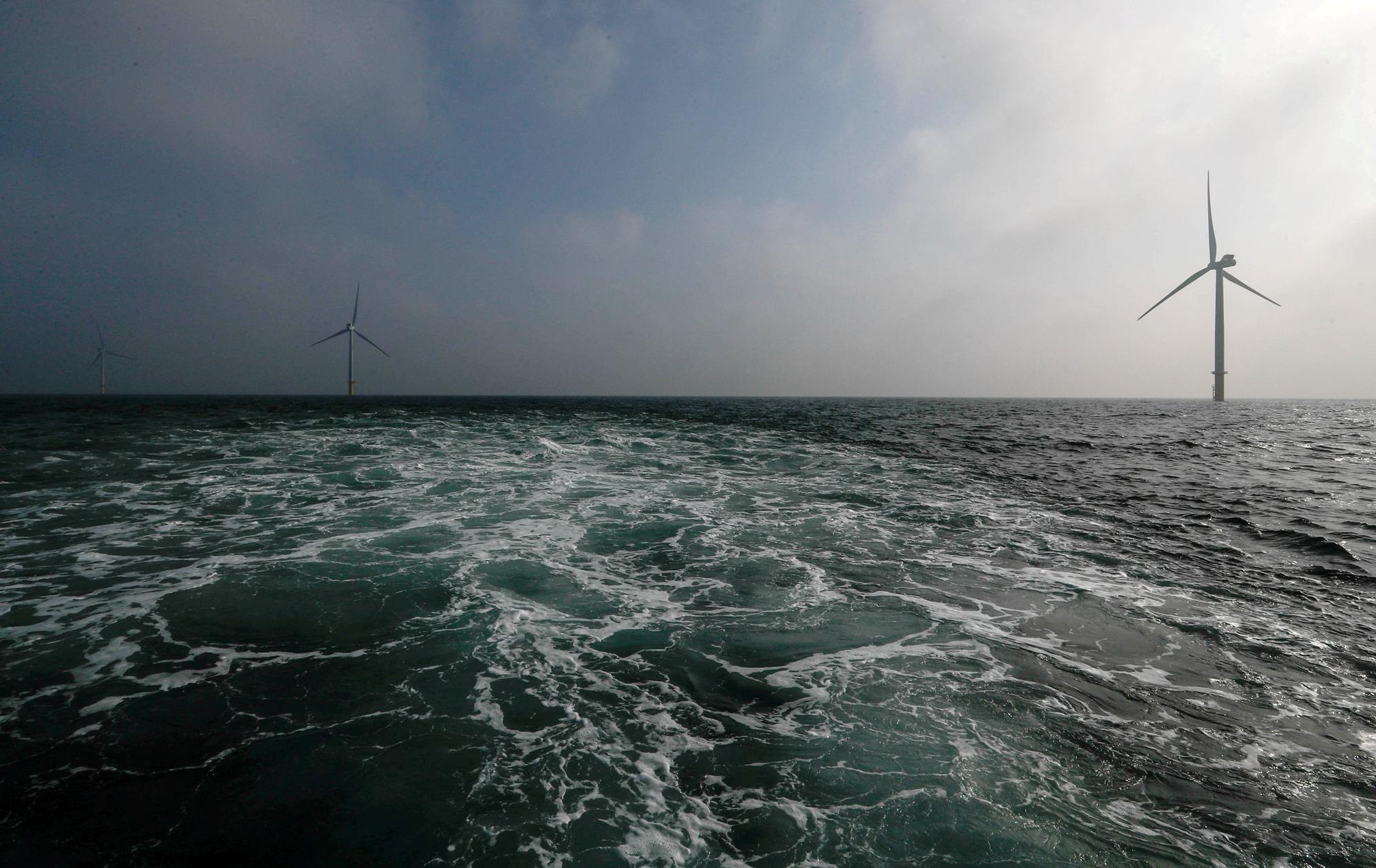 FILE PHOTO: Power-generating windmill turbines are seen at the Eneco Luchterduinen offshore wind farm near Amsterdam, Netherlands September 26, 2017. REUTERS/Yves Herman//File Photo