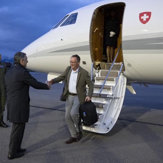 Swiss Federal Councilor Ignazio Cassis, left, welcomes Christian Winter, Swiss Ambassador of Sudan, at the Bern-Belp Airport in Belp, Switzerland, Tuesday, April 25, 2023. Swiss nationals are flown out of the crisis area in Sudan. (KEYSTONE/POOL/Peter Schneider)