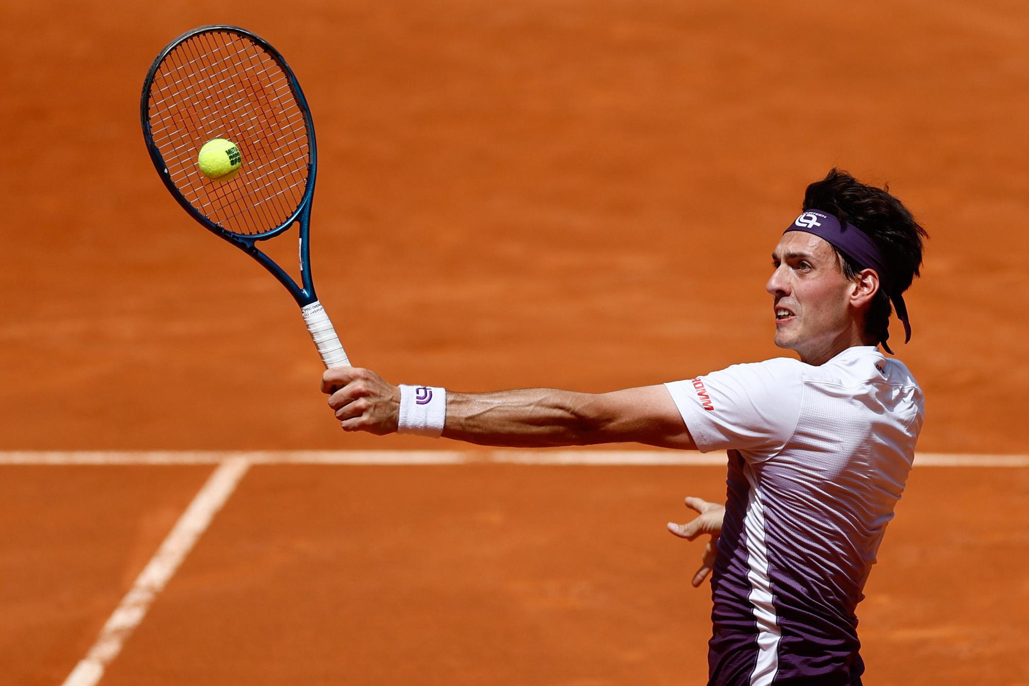 epa10594343 Marc-Andrea Huesler of Switzerland in action against Cristian Garin of Chile during their first round match of the Mutua Madrid Open tennis tournament in Madrid, Spain, 27 April 2023. EPA/RODRIGO JIMENEZ