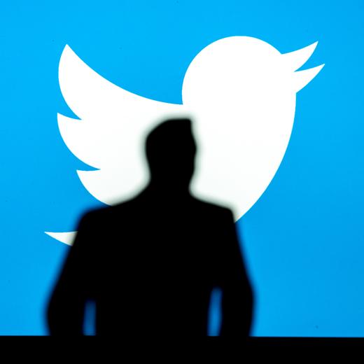 NEW YORK, USA, 2. OCTOBER 2022: Silhouette of businessman Elon Musk, logo of Twitter in blue background. Business photo, social media