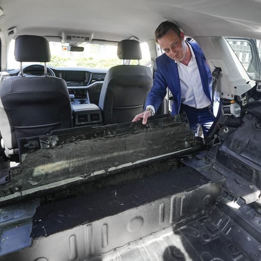 Eureka police operation manager Oliver Huth shows a hiding place in a converted SUV car, in which drugs were smuggled, during a press conference of the State Criminal Police Office in Duesseldorf, Germany, Wednesday, May 3, 2023. Police have arrested suspects and raided homes across Germany and Italy in a massive effort to clamp down on member of the Italian 'ndrangheta organized crime syndicate. (AP Photo/Martin Meissner)