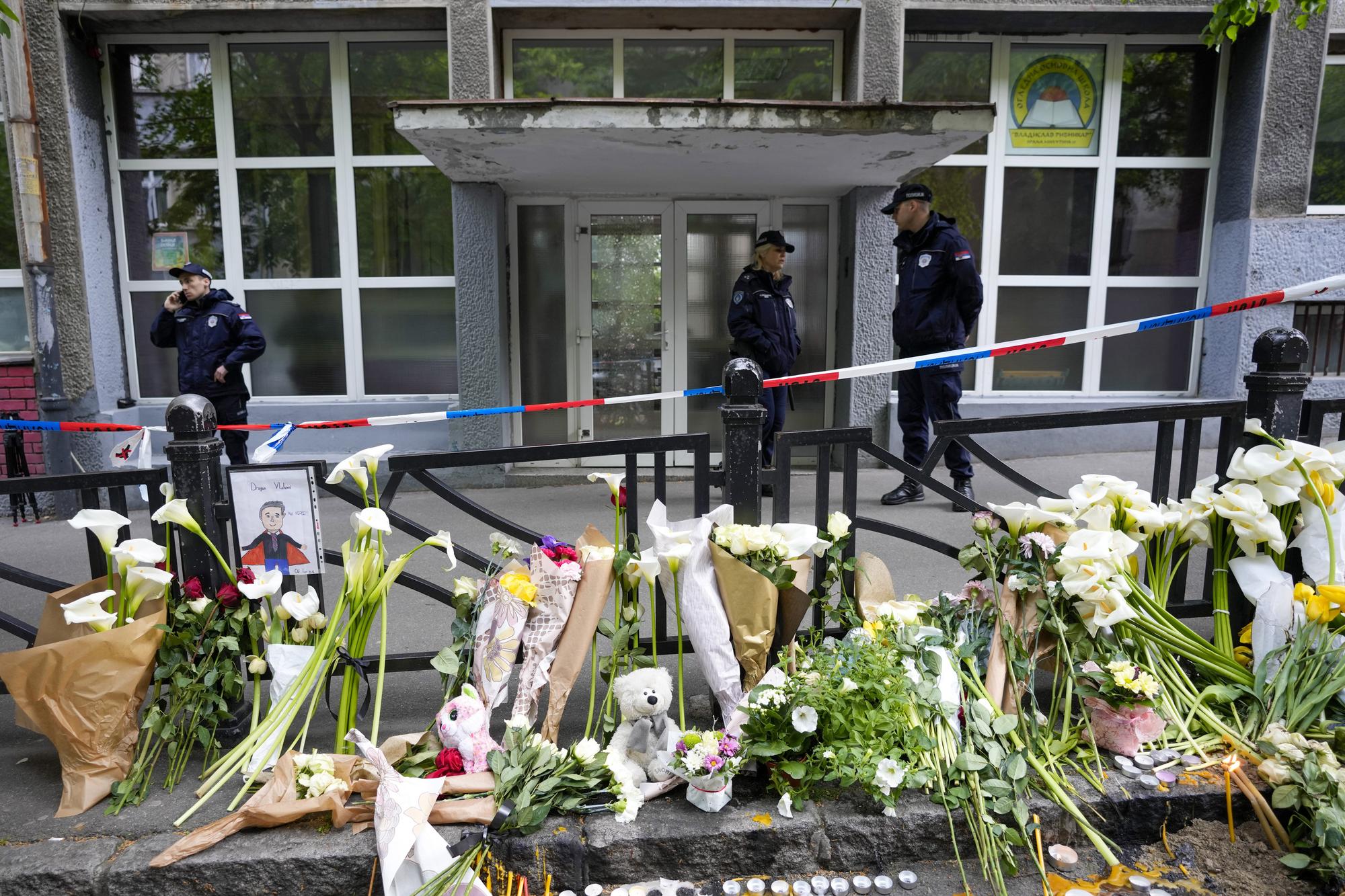 Police officers guard the Vladimir Ribnikar school in Belgrade, Serbia, Thursday, May 4, 2023. A 13-year-old who opened fire Wednesday at his school in Serbia's capital killed eight fellow students and a guard before calling the police and being arrested. (AP Photo/Darko Vojinovic)
