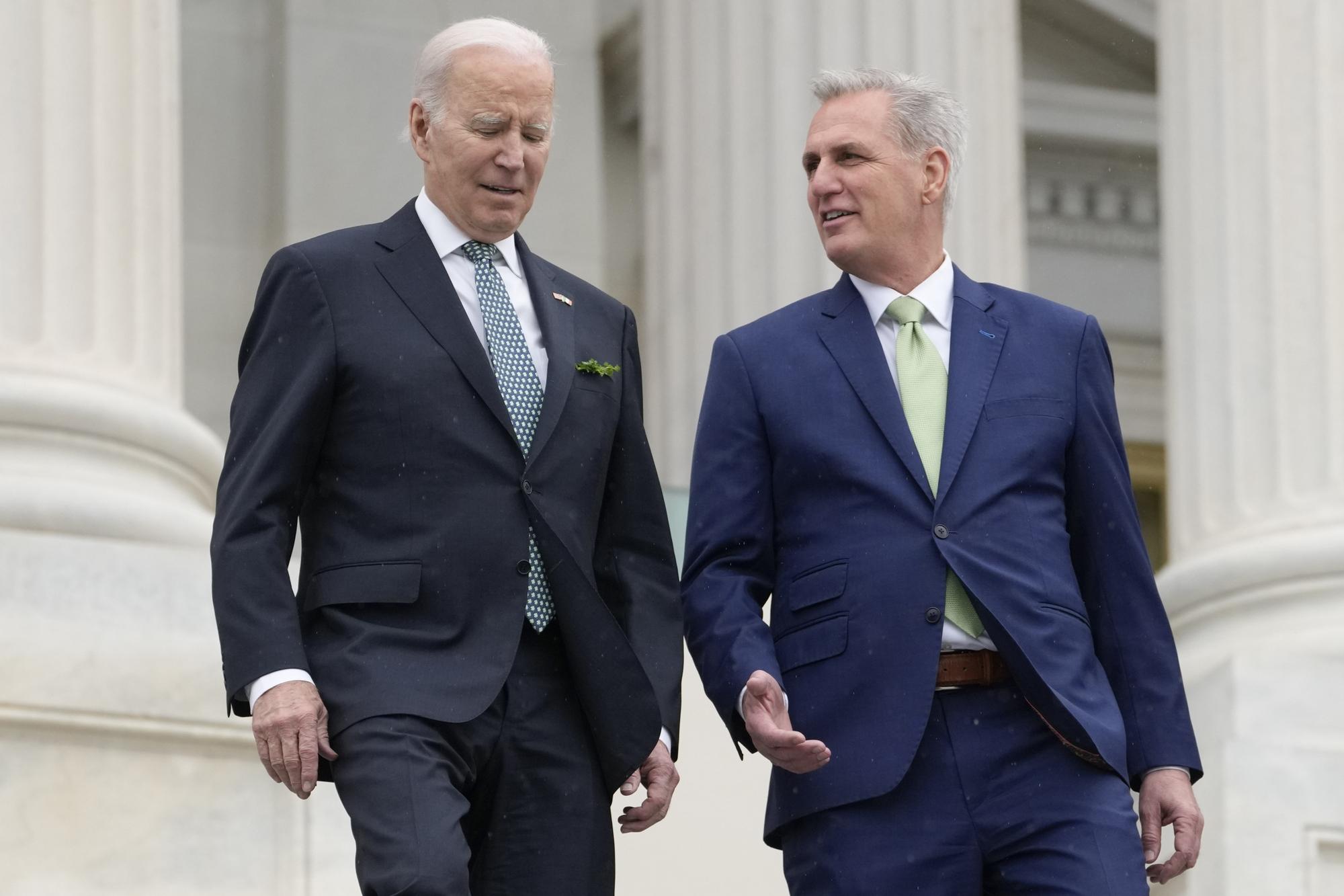 FILE - President Joe Biden talks with House Speaker Kevin McCarthy of Calif., as they walk down the House steps as they leave after attending an annual St. Patrick's Day luncheon gathering at the Capitol in Washington, March 17, 2023. The Tuesday, May 9, White House sitdown between the president and congressional leaders will be the first substantive talks between Biden and McCarthy in months, and comes weeks after House Republicans voted on a bill that would raise the debt limit but impose significant federal spending cuts. (AP Photo/Alex Brandon, File)  Joe Biden,Kevin McCarty