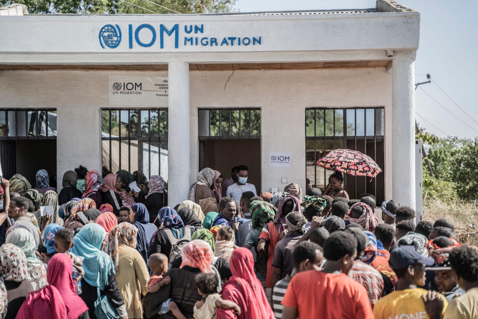 Refugees who crossed from Sudan to Ethiopia wait in line to register at IOM (International organization for Migration) in Metema, on May 4, 2023. More than 15,000 people have fled Sudan via Metema since fighting broke out in Khartoum in mid-April, according to the UN's International Organization for Migration, with around a thousand arrivals registered per day on average. (Photo by Amanuel Sileshi / AFP)