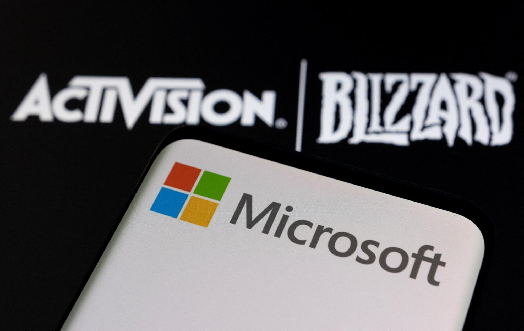 FILE PHOTO: Microsoft logo is seen on a smartphone placed on displayed Activision Blizzard logo in this illustration taken January 18, 2022. REUTERS/Dado Ruvic/Illustration/File Photo