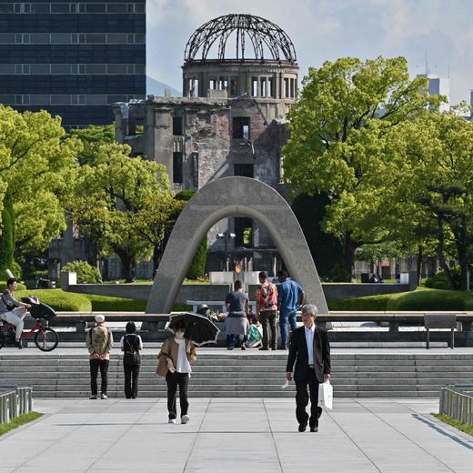 This photo taken on May 15, 2023 shows people visiting the Peace Memorial Park (front) and the Atomic Bomb Dome (behind) in Hiroshima, just days ahead of the arrival of leaders for the G7 Leaders' Summit. G7 leaders meet in Hiroshima from May 19-21, looking to tighten the screws further on Russia over the Ukraine war and agree a united line on China's growing military and economic power. (Photo by Richard A. Brooks / AFP)