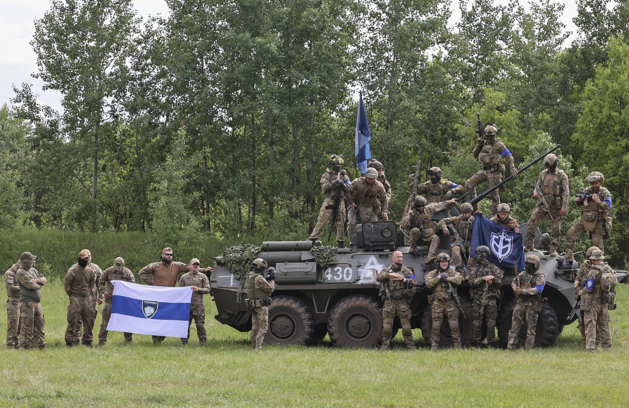 epa10650539 Members of the 'Russian Volunteer Corps' and 'Freedom of Russia Legion' hold a meeting with the media not far from the Ukraine-Russia border in Kharkiv's area, northeastern Ukraine, 24 May 2023, amid the Russian invasion. According to the group of Russian fighters, who are aligned with Ukraine, during a meeting with the press on 24 May, they engaged in cross-border raids on the territory of the Belgorod region of Russia starting on 22 May 2023. Ukraine has denied Russia's allegation that it was behind the attacks on the Belgorod region and portrayed the incursions by the Russian volunteers as an uprising against the Kremlin and Putin's regime. Russian troops entered Ukraine on 24 February 2022 starting a conflict that has provoked destruction and a humanitarian crisis. EPA/SERGEY KOZLOV