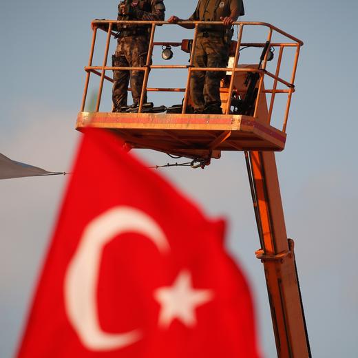 Turkish special forces unit stand on a crane during a Democracy and Martyrs' Rally in Istanbul, Sunday, Aug. 7, 2016. A massive flag-waving crowd, the size of which some Turkish media said had never been seen before, gathered in Istanbul Sunday for a giant rally to mark the end of nightly demonstrations since Turkey's July 15 abortive coup that left more than 270 people dead. (AP Photo/Emrah Gurel)