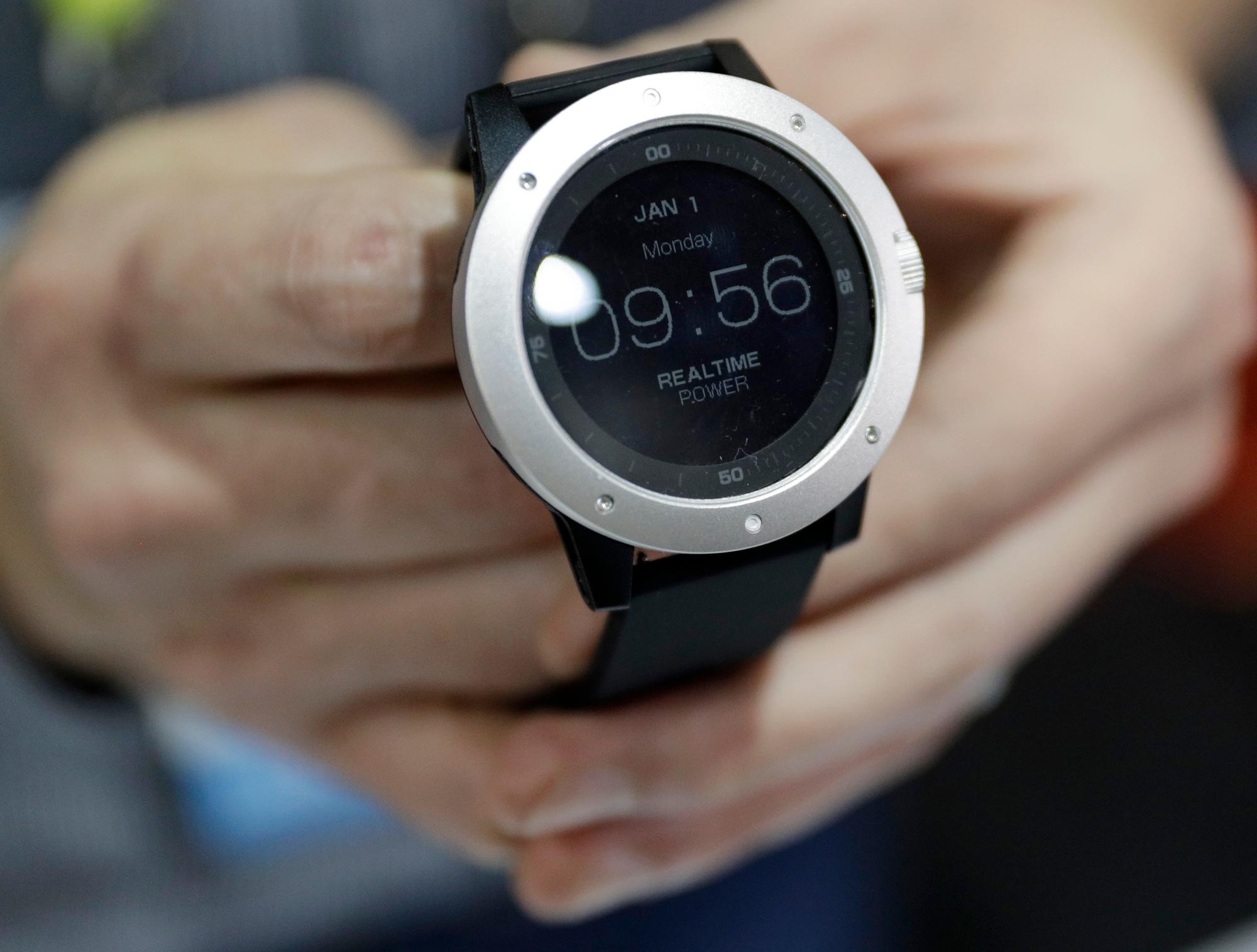 An employee demonstrates the Matrix Powerwatch during CES Unveiled before CES International, Tuesday, Jan. 3, 2017, in Las Vegas. The smart watch is powered by body heat from the wearer. (AP Photo/John Locher)