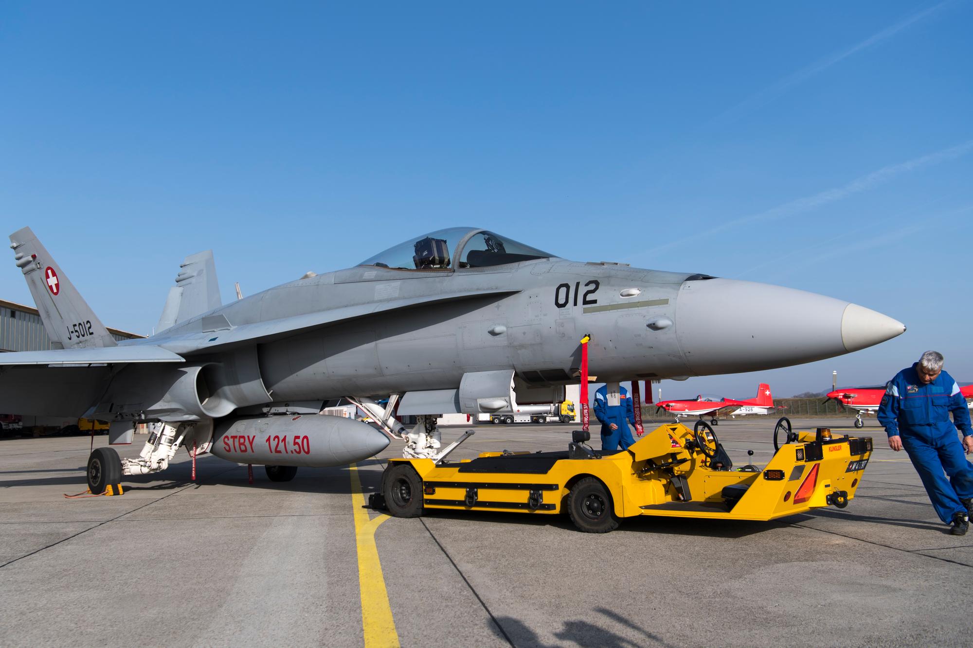 Des états-majors des Forces aériennes suisses sortent un avion de combat F/A-18 Hornet de son hangar de la base aérienne à Payerne, le mardi 19 février 2019.