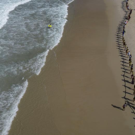 People create a line holding hands along Sao Conrado beach for a symbolic group hug with the sea on World Oceans Day in Rio de Janeiro, Brazil, Thursday, June 8, 2023. The Route Brasil environmental organization called for people to gather for the event coined "That Hug" to draw attention to ocean pollution. (AP Photo/Bruna Prado)