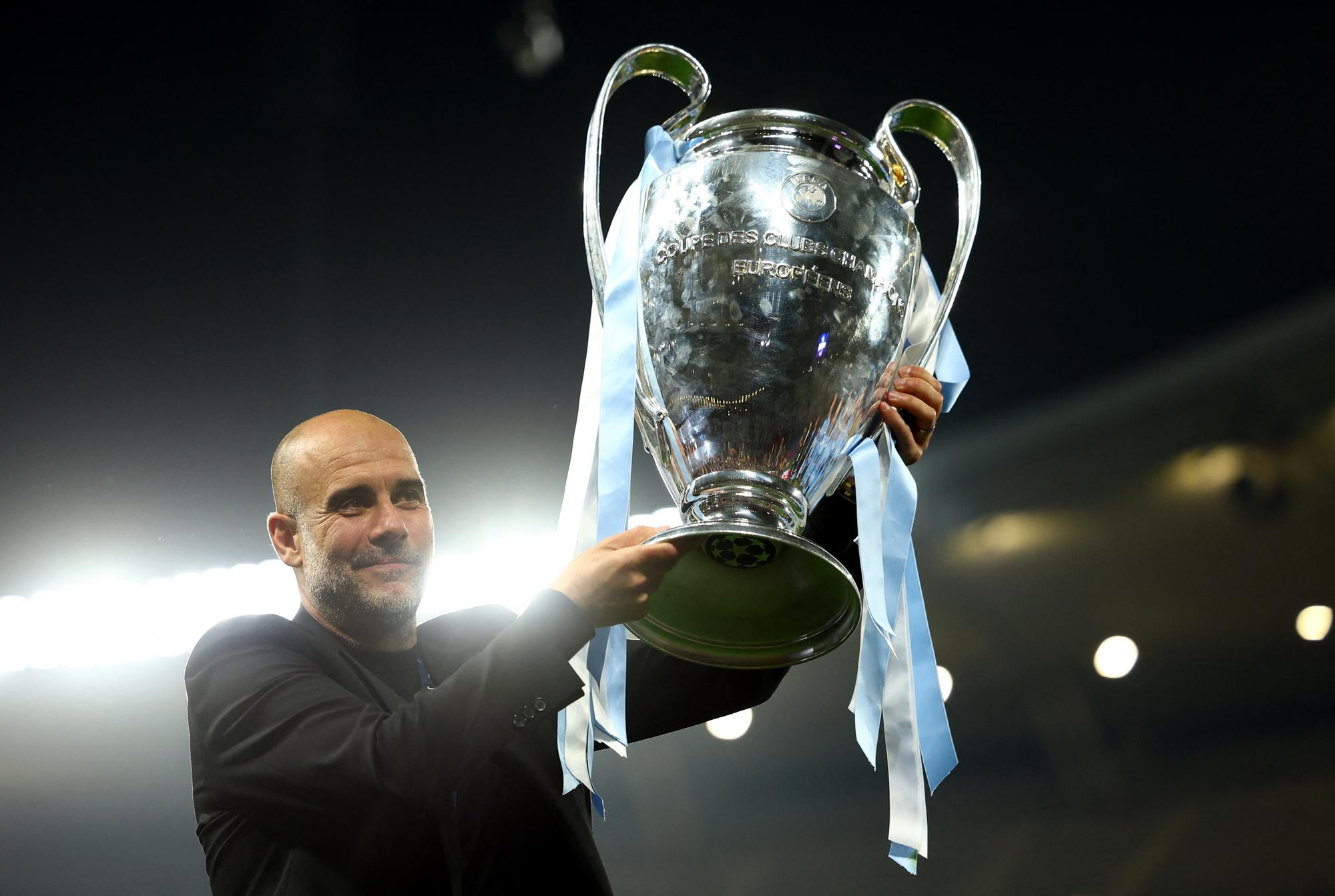 Soccer Football - Champions League Final - Manchester City v Inter Milan - Ataturk Olympic Stadium, Istanbul, Turkey - June 11, 2023  Manchester City manager Pep Guardiola celebrates with the trophy after winning the Champions League REUTERS/Molly Darlington
