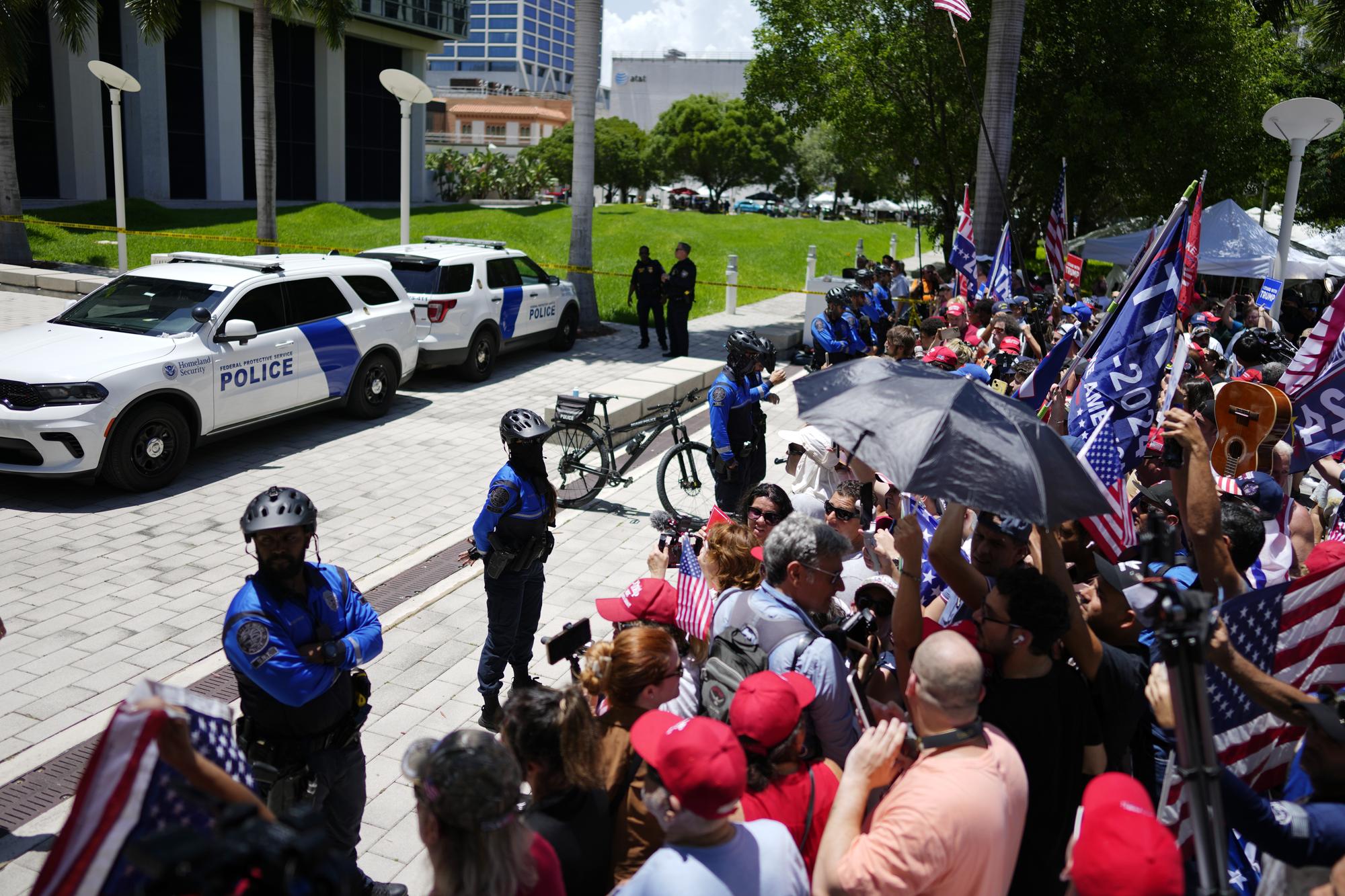 Supporters wait for the arrival of former President Donald Trump at the Wilkie D. Ferguson Jr. U.S. Courthouse, Tuesday, June 13, 2023, in Miami. Trump is making a federal court appearance on dozens of felony charges accusing him of illegally hoarding classified documents and thwarting the Justice Department's efforts to get the records back. (AP Photo/Rebecca Blackwell)