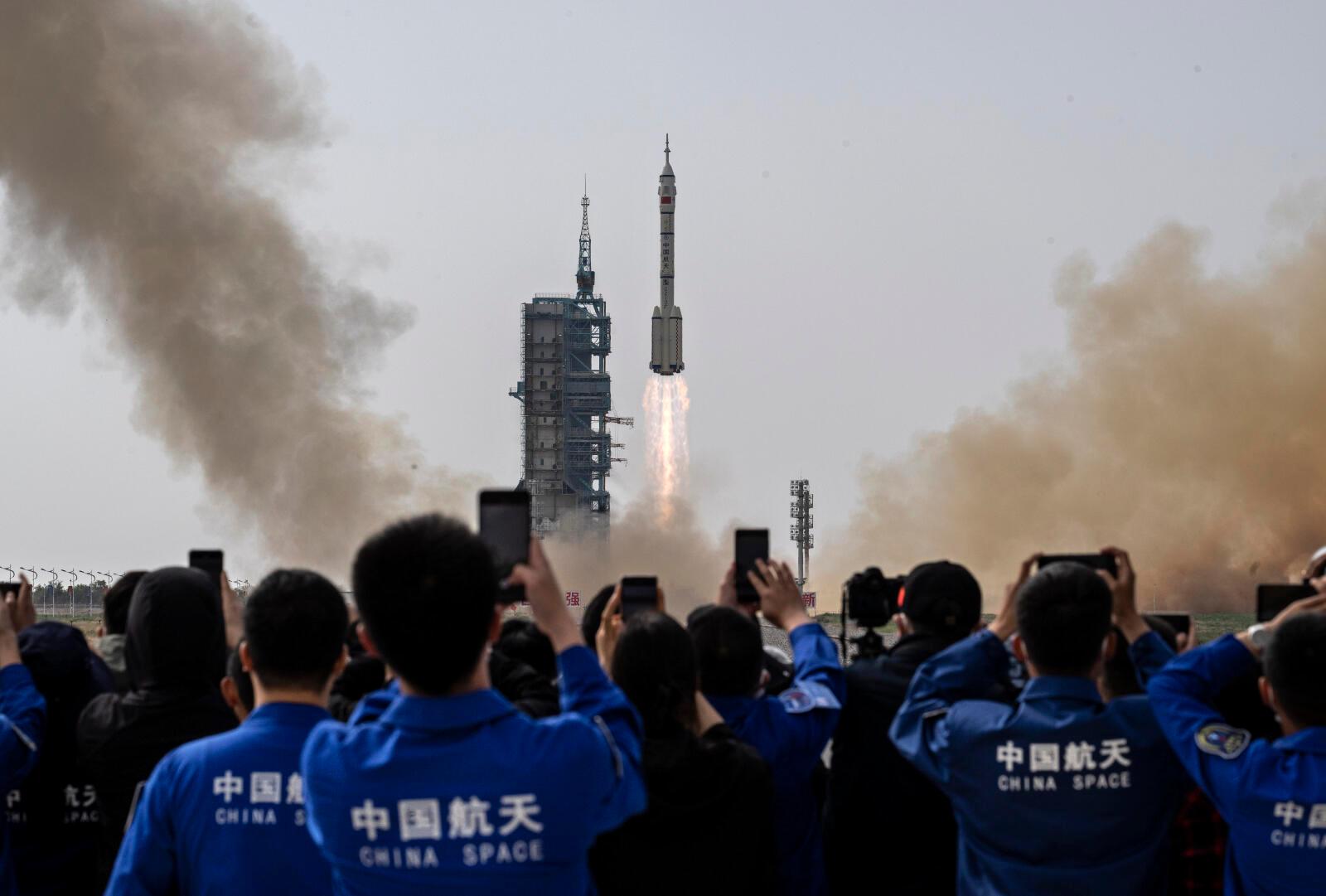 JIUQUAN, CHINA - MAY 30: Members from China's Manned Space Agency and visitors watch as the Shenzhou-16 spacecraft onboard the Long March-2F rocket launches at the Jiuquan Satellite Launch Center on May 30, 2023 in Jiuquan, China. The three astronaut crew of the Shenzhou-16 spacecraft will be carried to China's new Tiangong Space Station and will replace a similar crew that have been at the station for the last six months. (Photo by Kevin Frayer/Getty Images) ***BESTPIX***