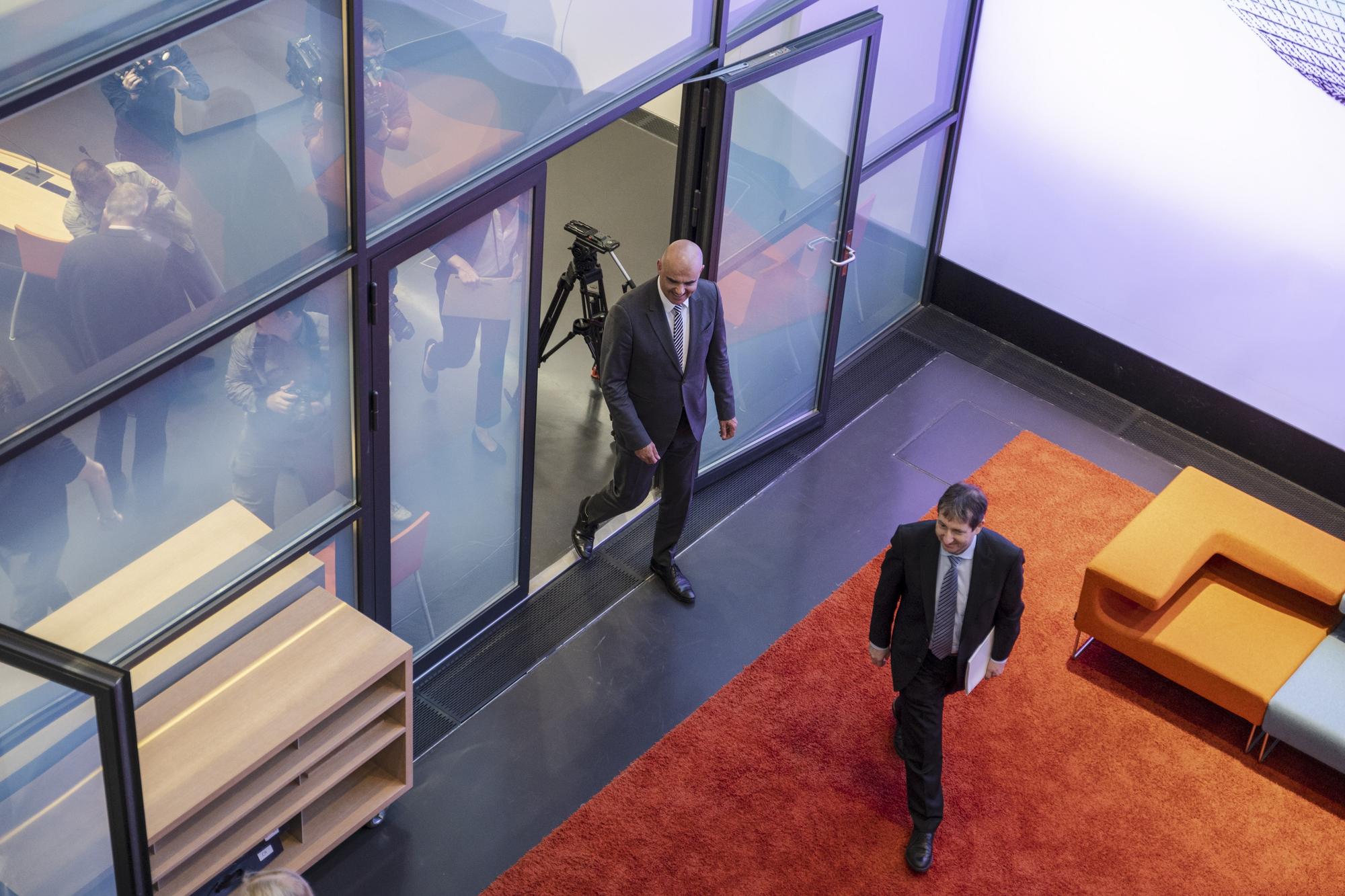 epa10703708 Swiss President Alain Berset (back) and Federal Council spokesman Andre Simonazzi (front) leave after a media conference where Berset announced his resignation from the Federal Council at the end of the year, in Bern, Switzerland, 21 June 2023. 'I will not be running for another legislature in the Federal Council at the end of the year', he said. EPA/MARCEL BIERI